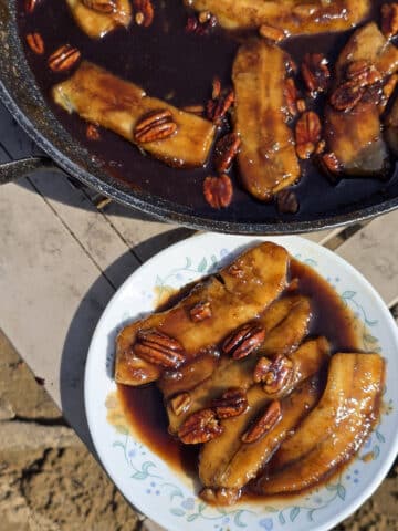 A skillet and plate of camping bananas foster.