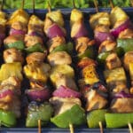 Several Sesame ginger Chicken and Pineapple Kebabs, with juicy marinated chicken pieces, pineapple chunks, green bell pepper, and red onion.