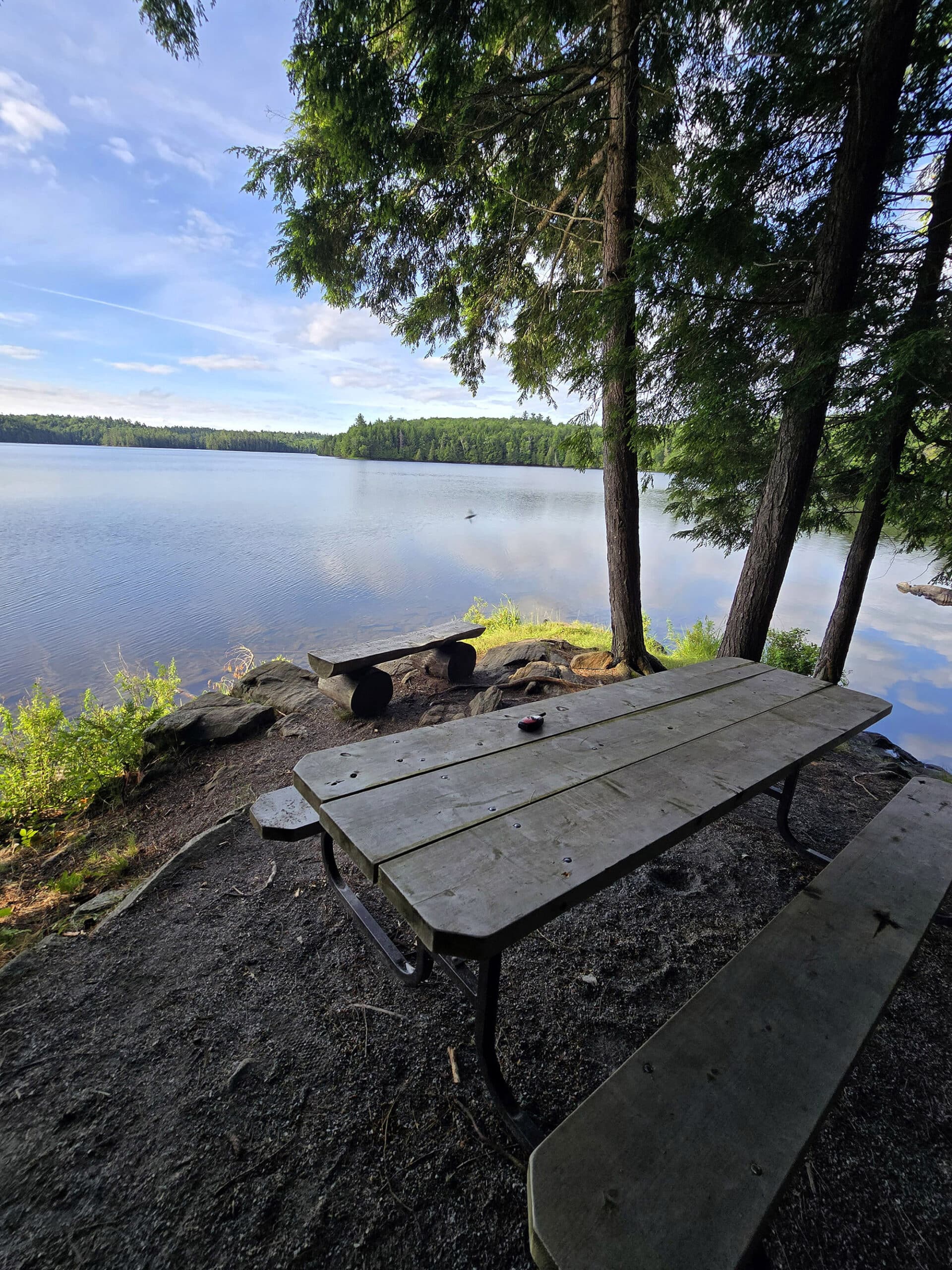 A view over Silent Lake with a picnic table in the foreground.