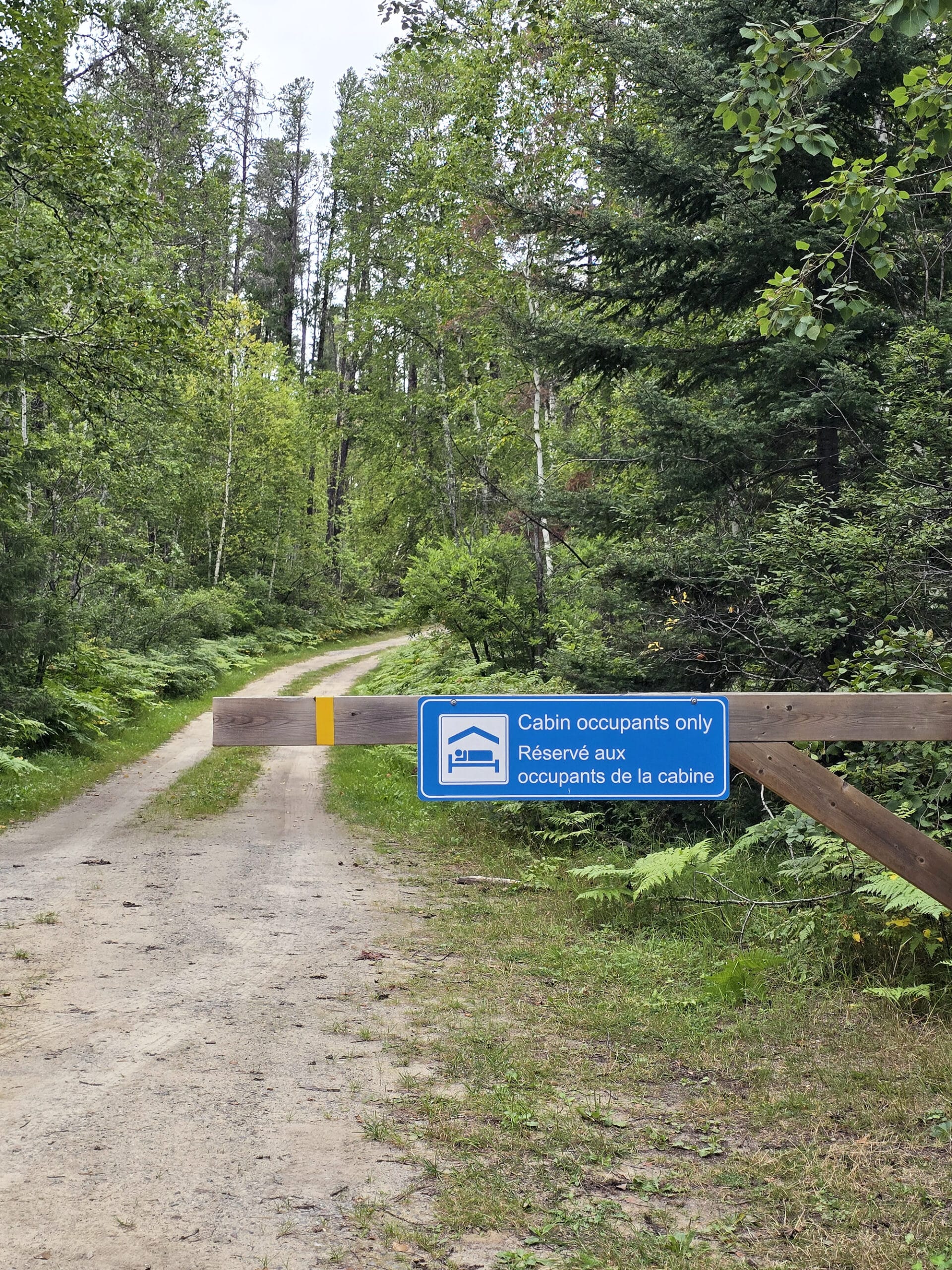 A gated road leading to the rental cabin at kettle lakes provincial park.