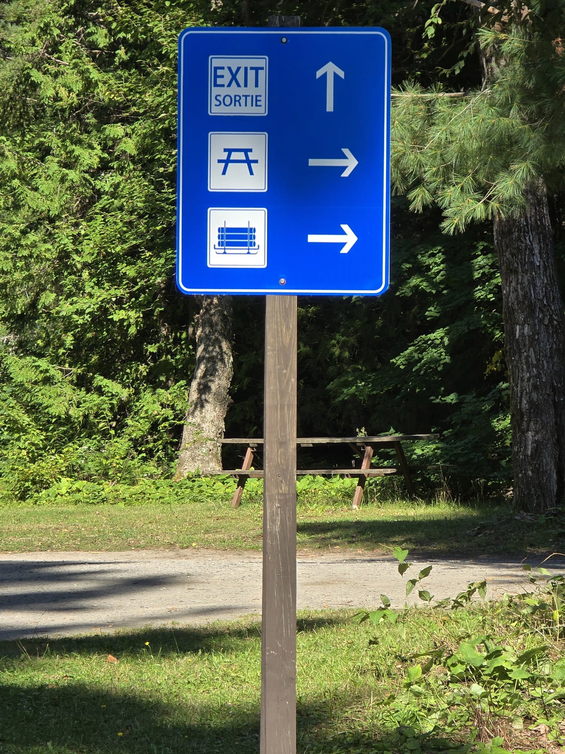 A blue and white directional road sign.