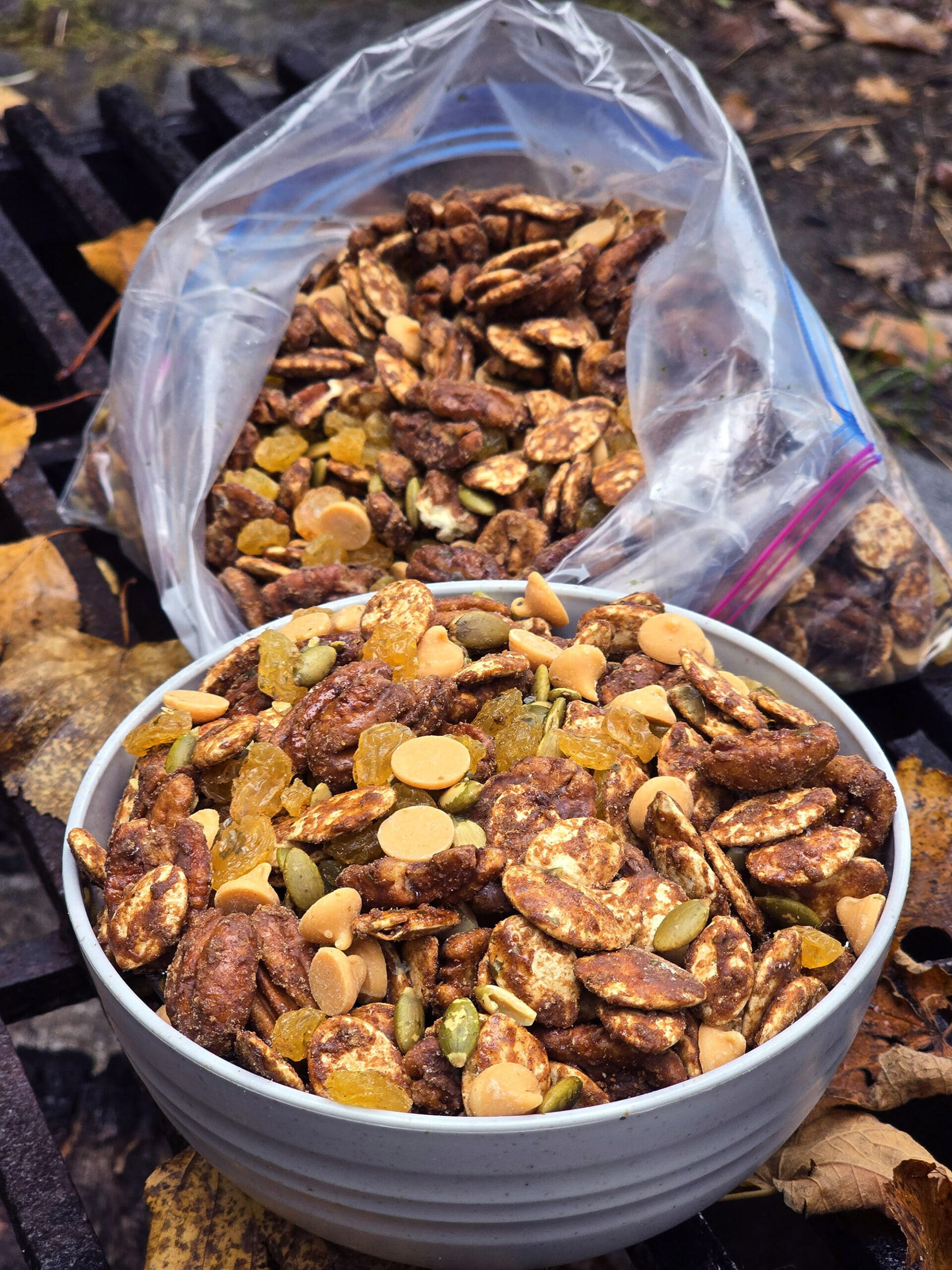 A bowl and a bag of homemade pumpkin spice trail mix.