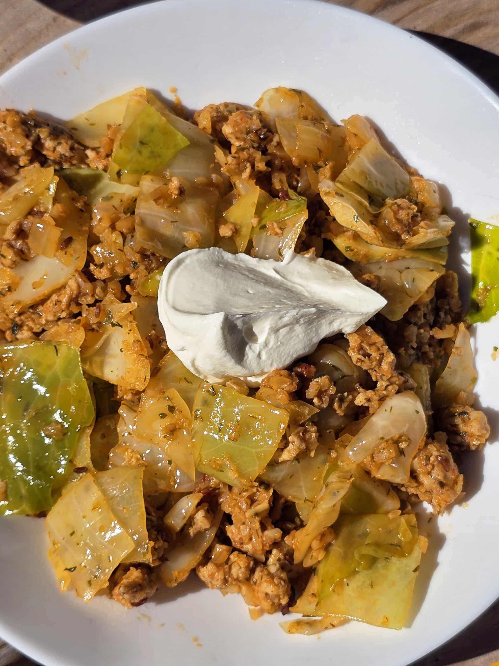 A pan and bowl of lazy cabbage roll stir fry.