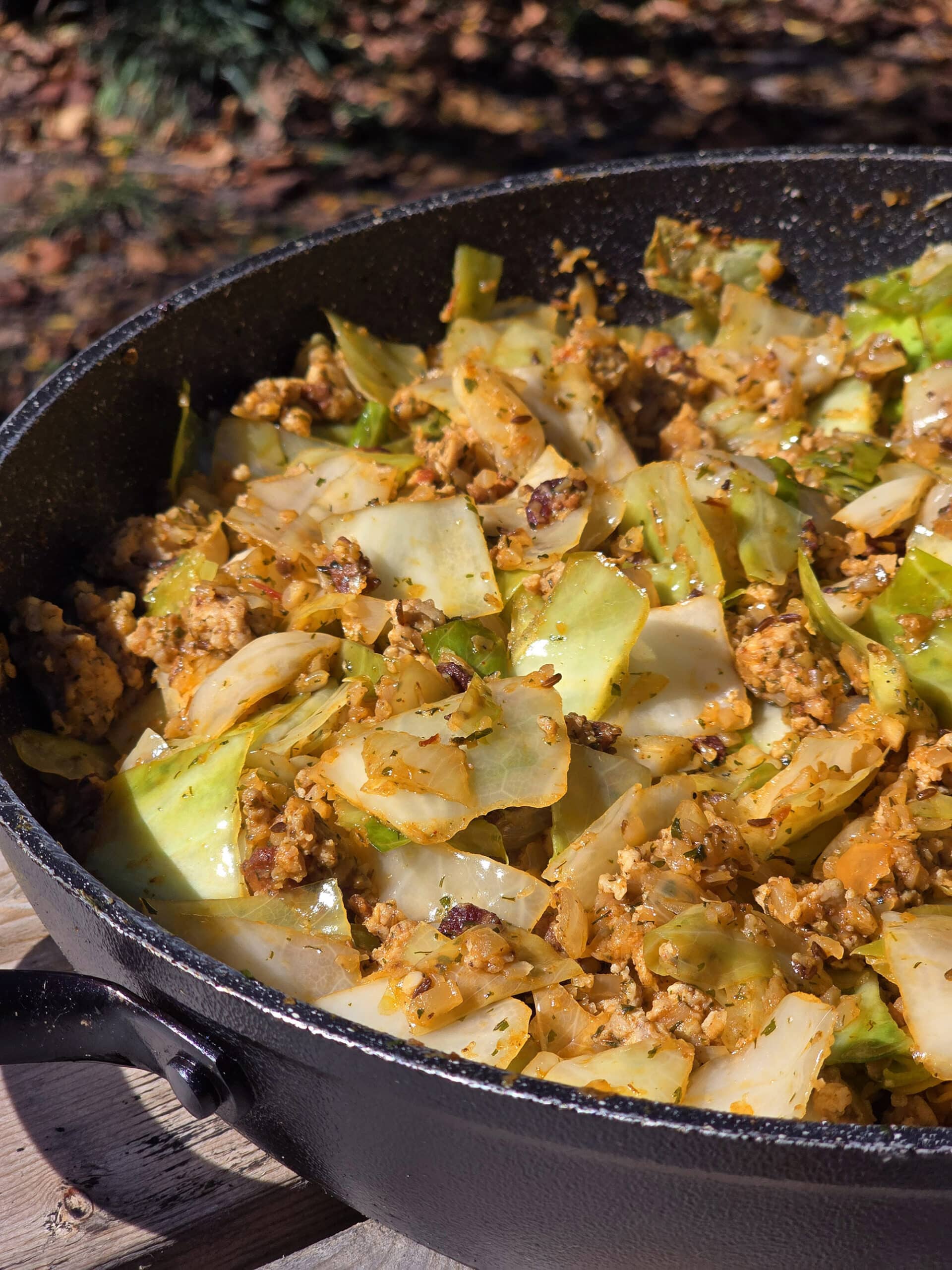 A pan of cabbage roll in a bowl, with ground meat, cabbage, tomato, and more.