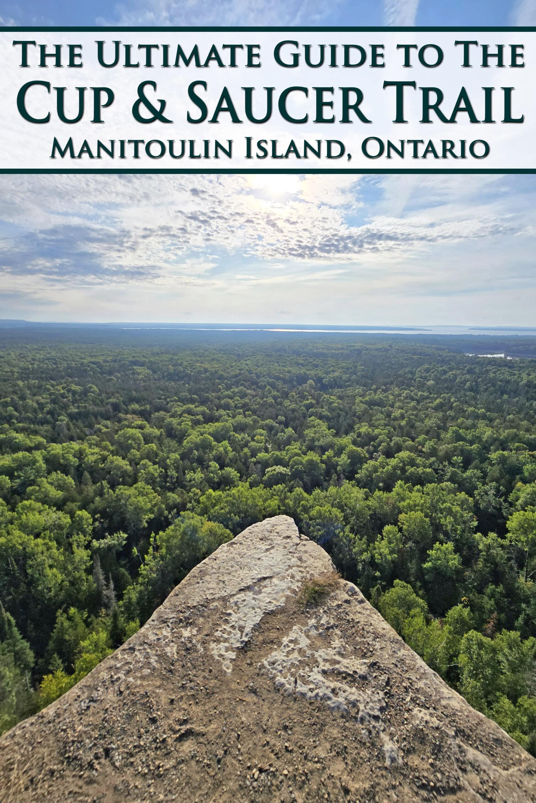 A view over the side of a tall, peaked cliff. Overlaid text says The Ultimate Guide to the Cup and Saucer Trail, Manitoulin Island, Ontario.