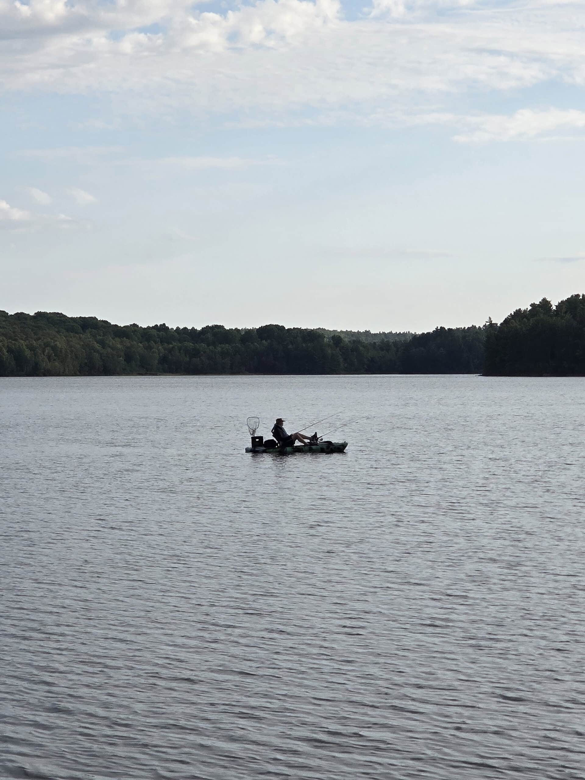 A small fishing boat on stormy lake at Restoule Provincial Park.