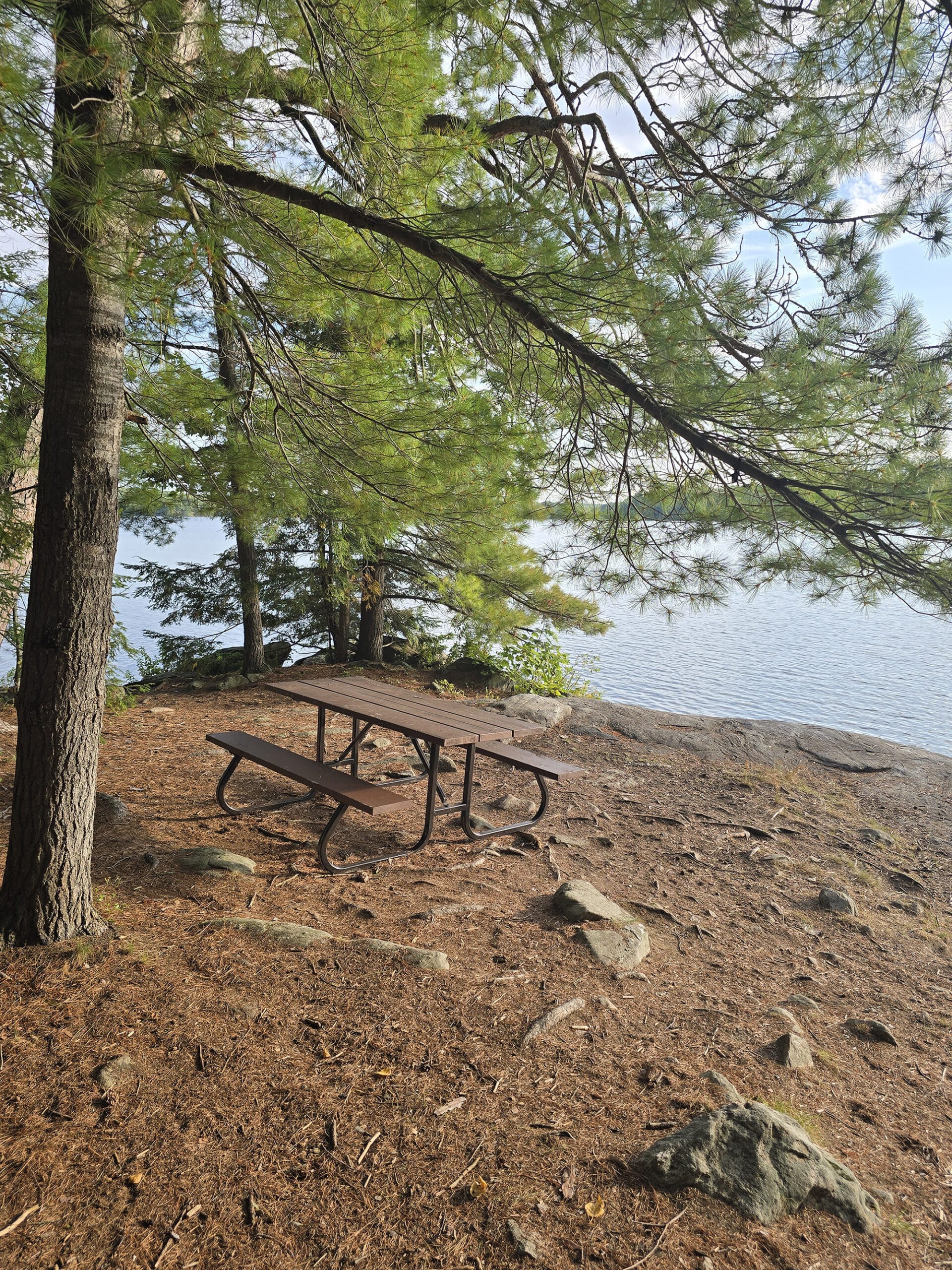 A picnic table overlooking stormy lake at Restoule Provincial Park.