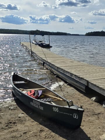 A canoe next to a boat dock on restoule lake, at restoule provincial park.