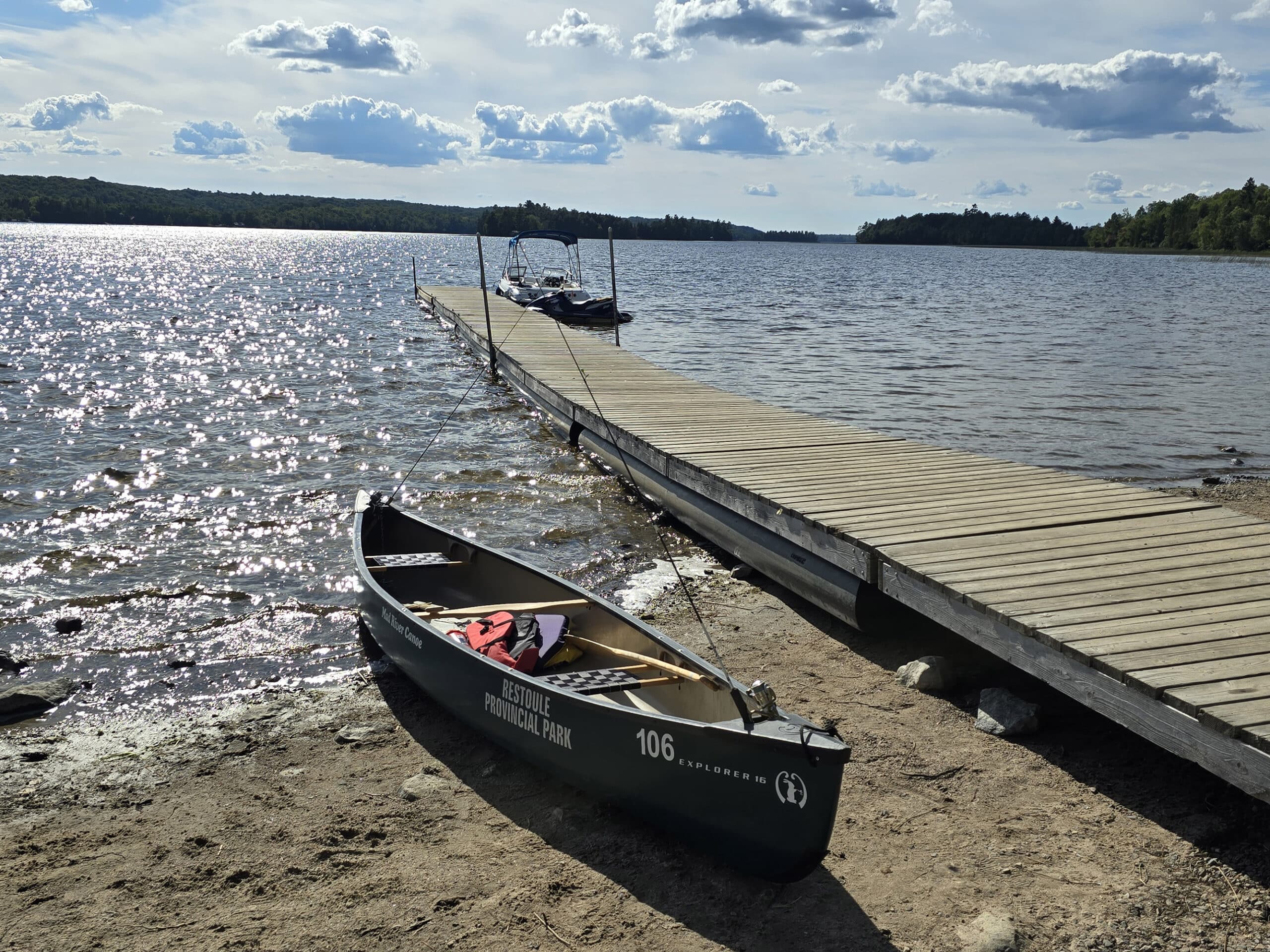 A canoe next to a boat dock on restoule lake, at restoule provincial park.