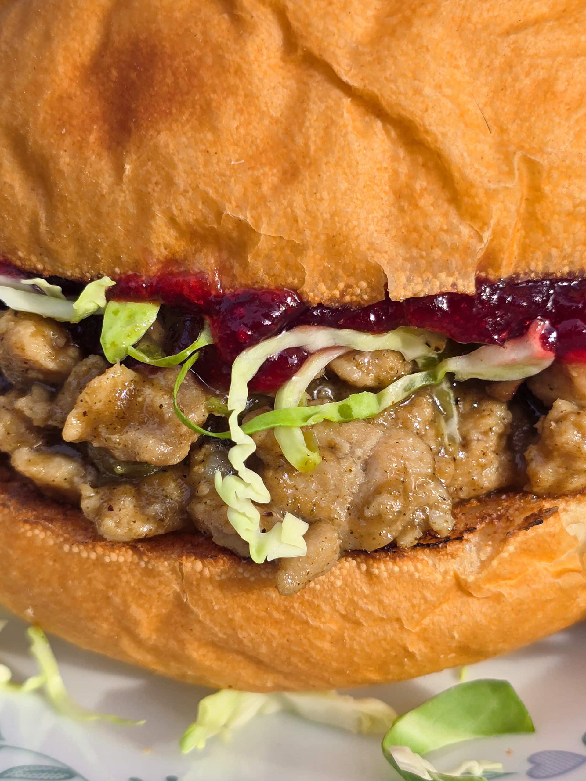 A Thanksgiving Sloppy Joes Sandwich with ground turkey, veggies, gravy, cranberry sauce, and shredded Brussels Sprouts.