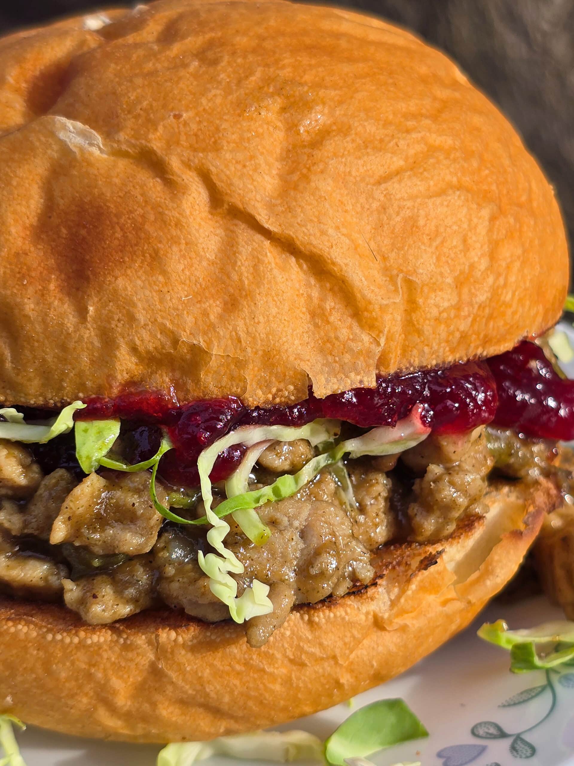 A Thanksgiving Turkey Sloppy Joes Sandwich with ground turkey, veggies, gravy, cranberry sauce, and shredded Brussels Sprouts.