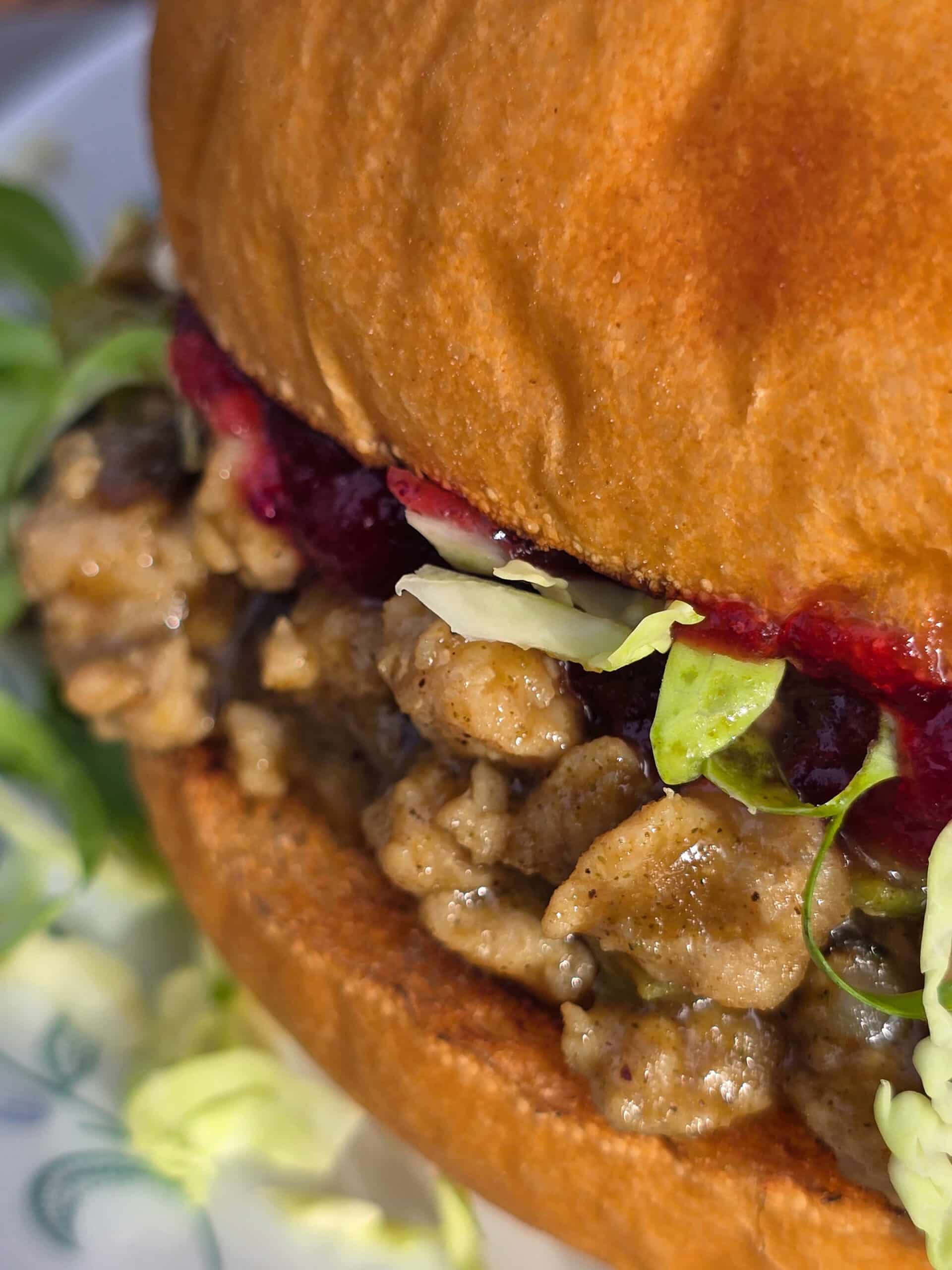 A Thanksgiving Sloppy Joes Sandwich with ground turkey, veggies, gravy, cranberry sauce, and shredded Brussels Sprouts.