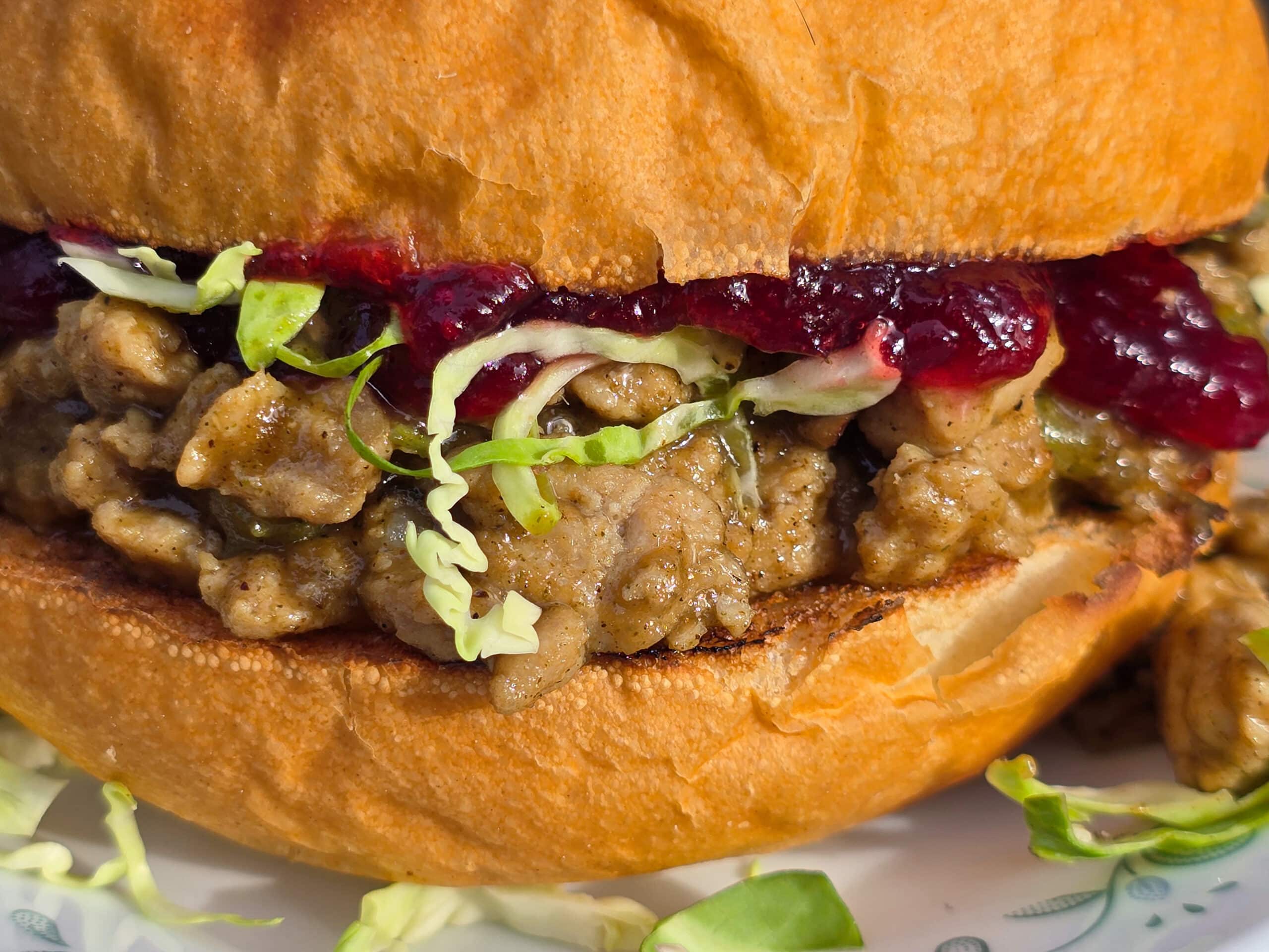 A Thanksgiving Sloppy Joes Sandwich with ground turkey, veggies, gravy, cranberry sauce, and shredded Brussels Sprouts.