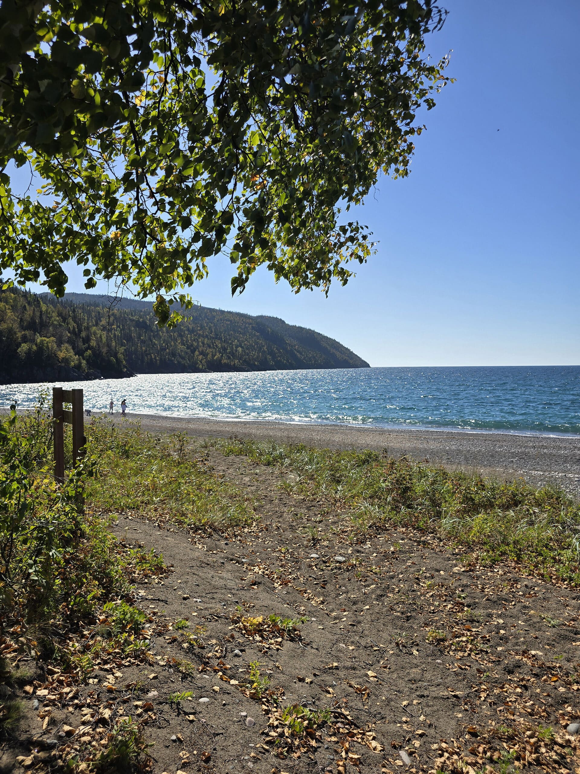 Schreiber Beach, a rocky lake superior beach with glistening blue water.