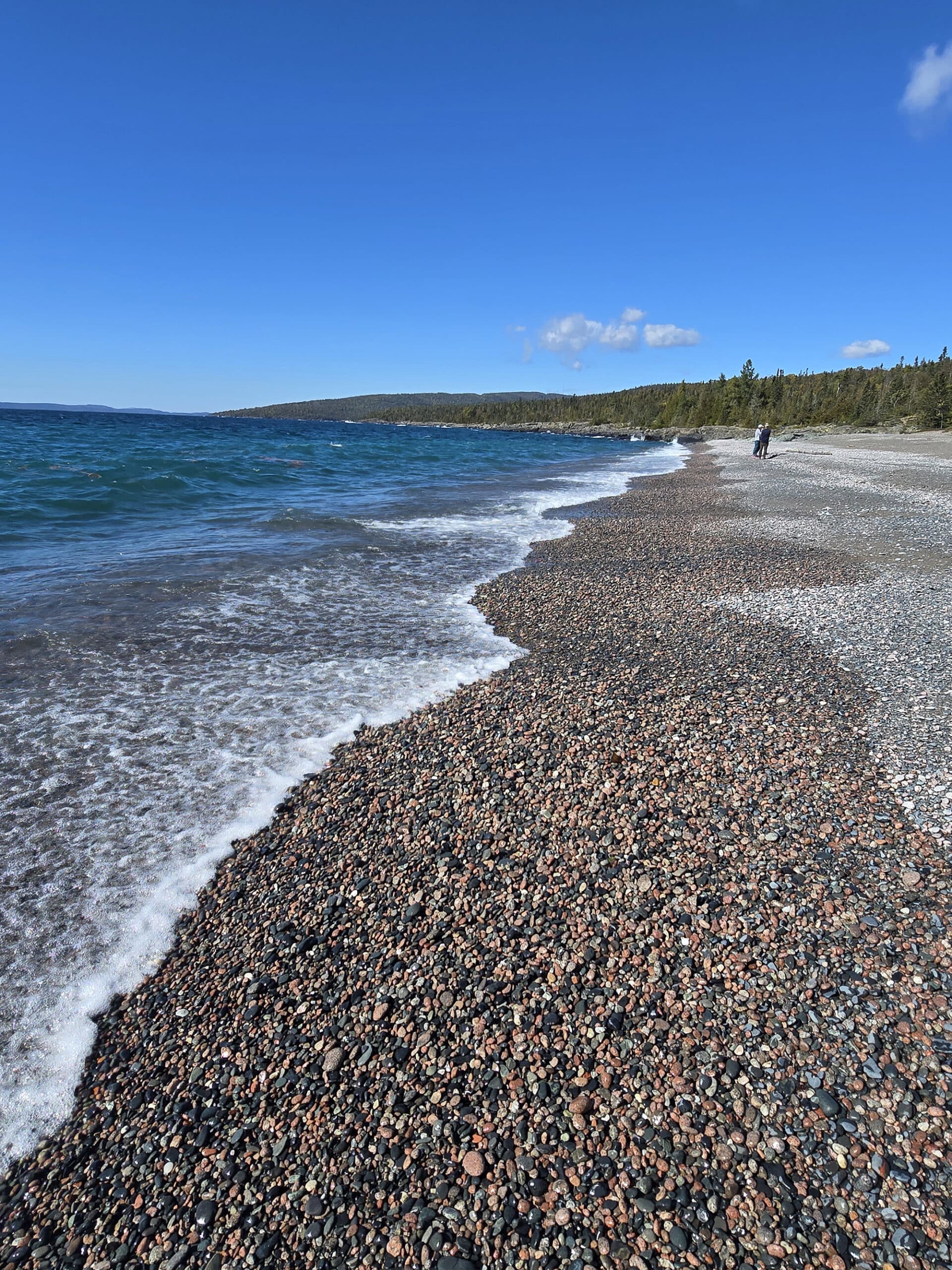 Schreiber Beach, a rocky lake superior beach with glistening blue water.