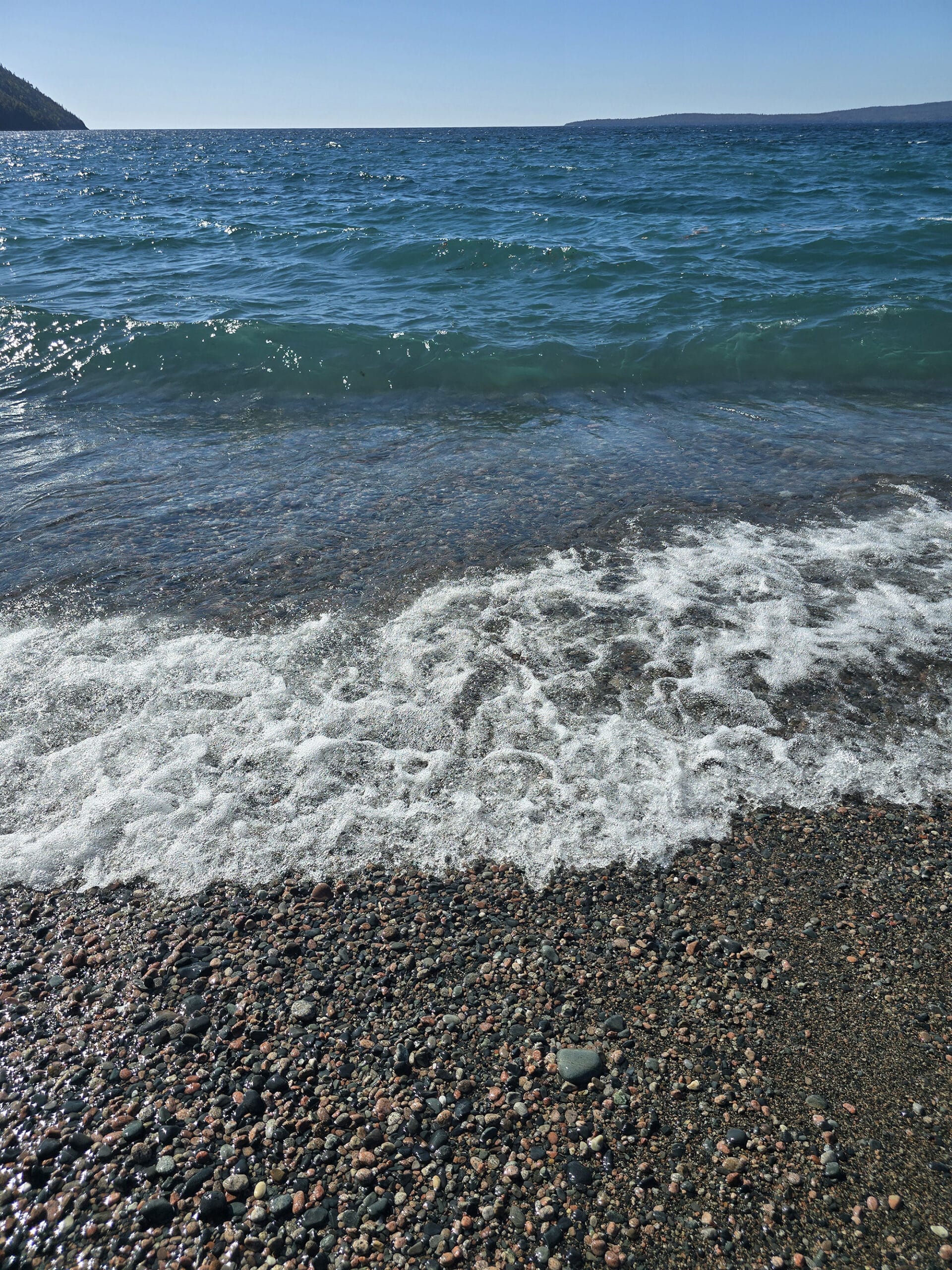 Schreiber Beach, a rocky lake superior beach with glistening blue water.