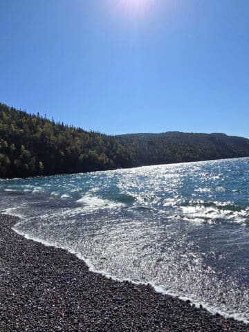 Schreiber Beach, a rocky lake superior beach with glistening blue water.