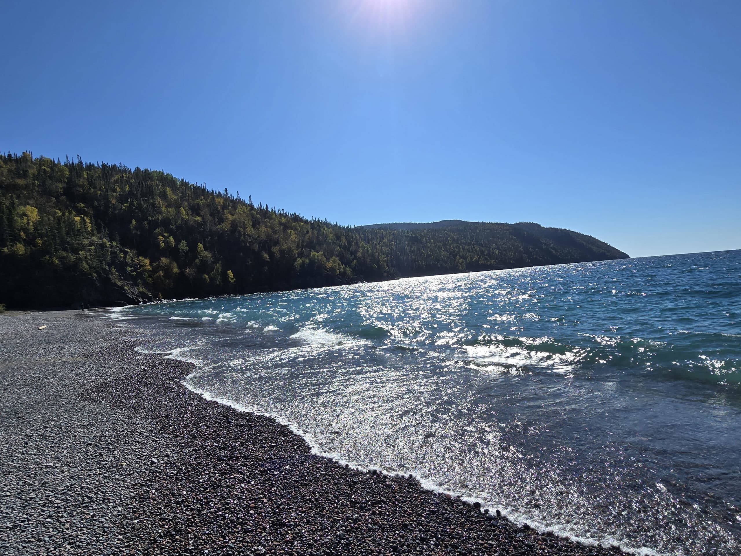 Schreiber Beach, a rocky lake superior beach with glistening blue water.