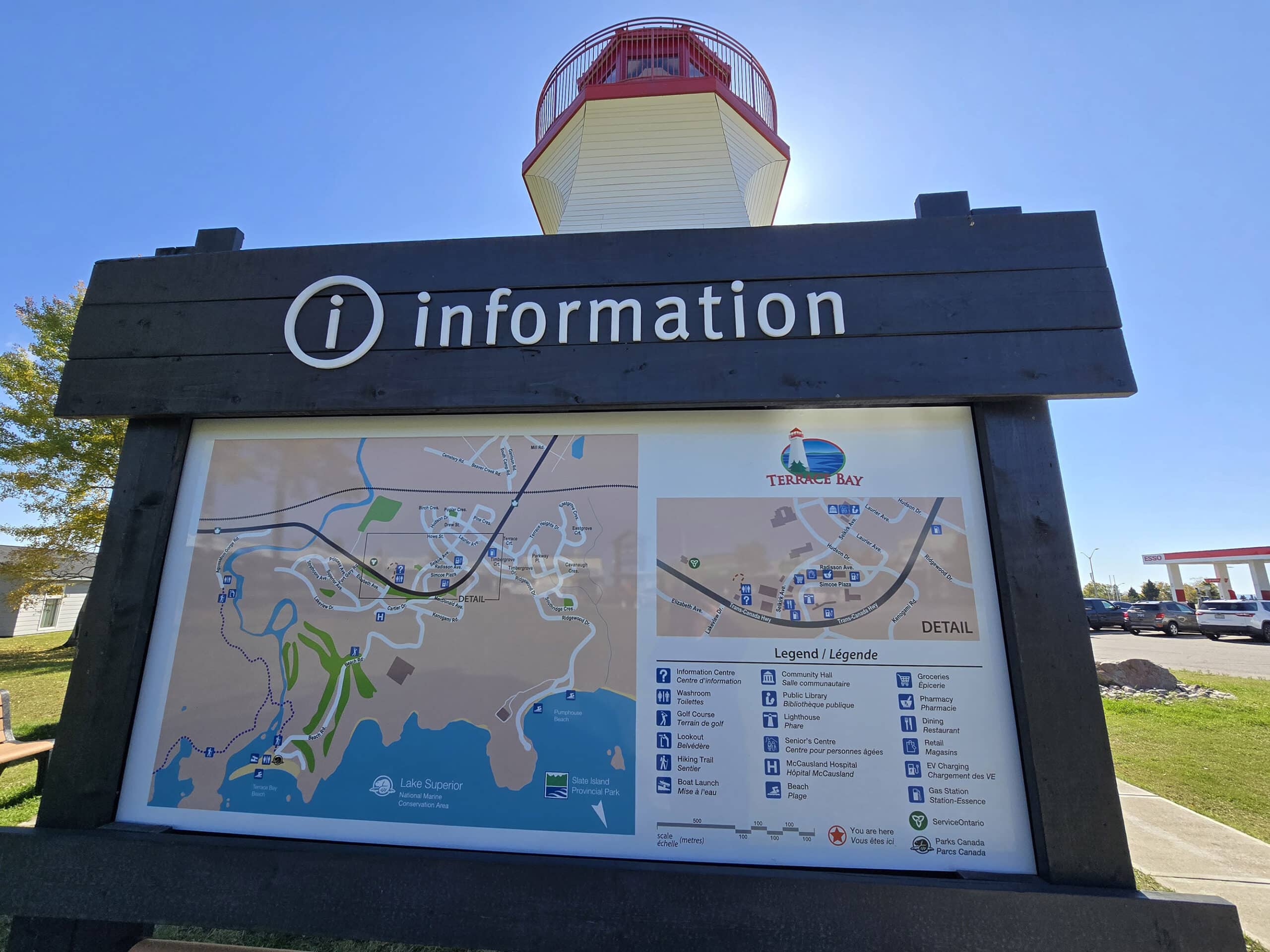An information board and map in front of the terrace bay lighthouse.