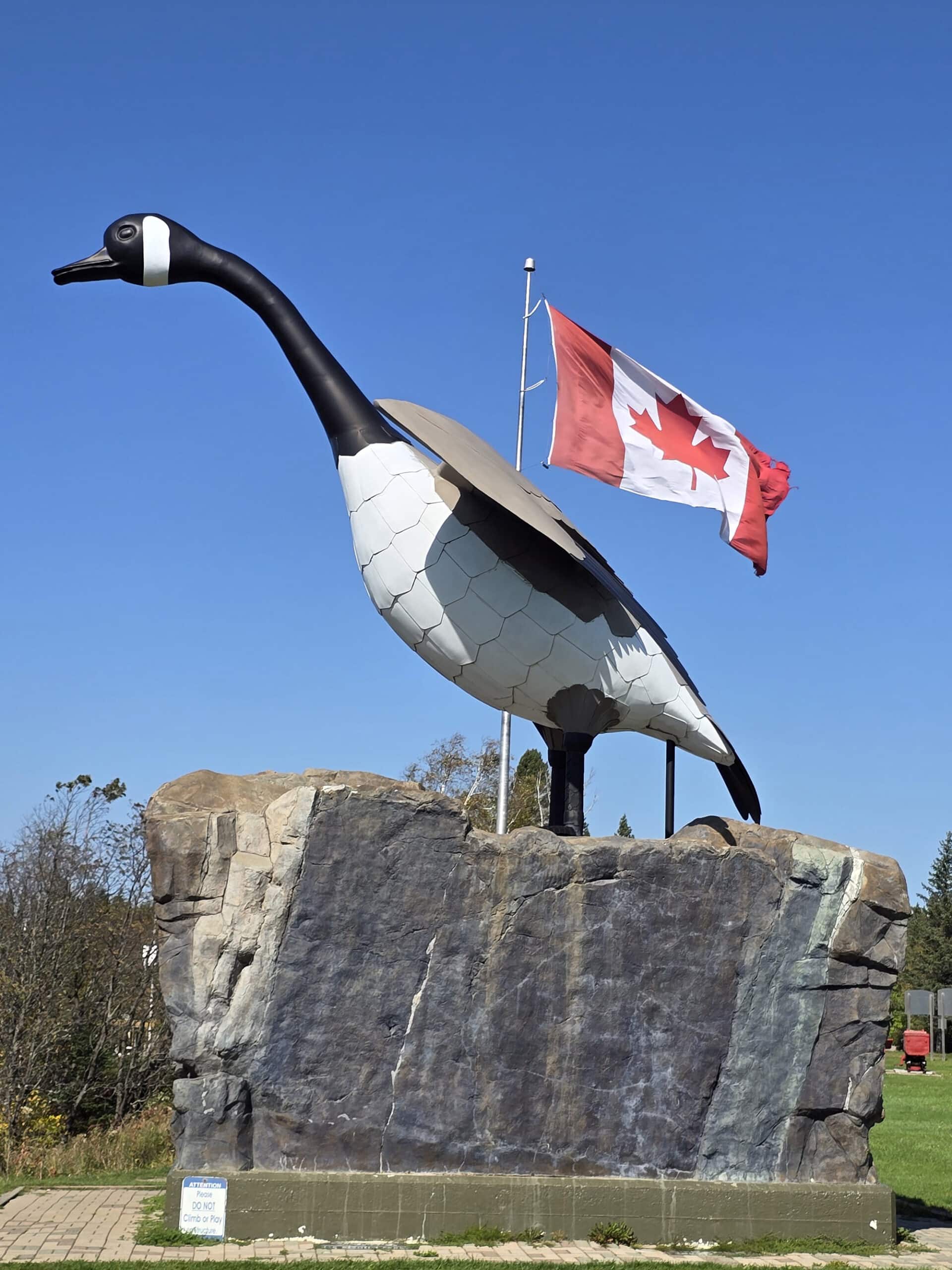 The Wawa Canada Goose Statue with a Canadian Flag in the background.