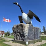 The wawa goose statue with a Canadian flag in the background.