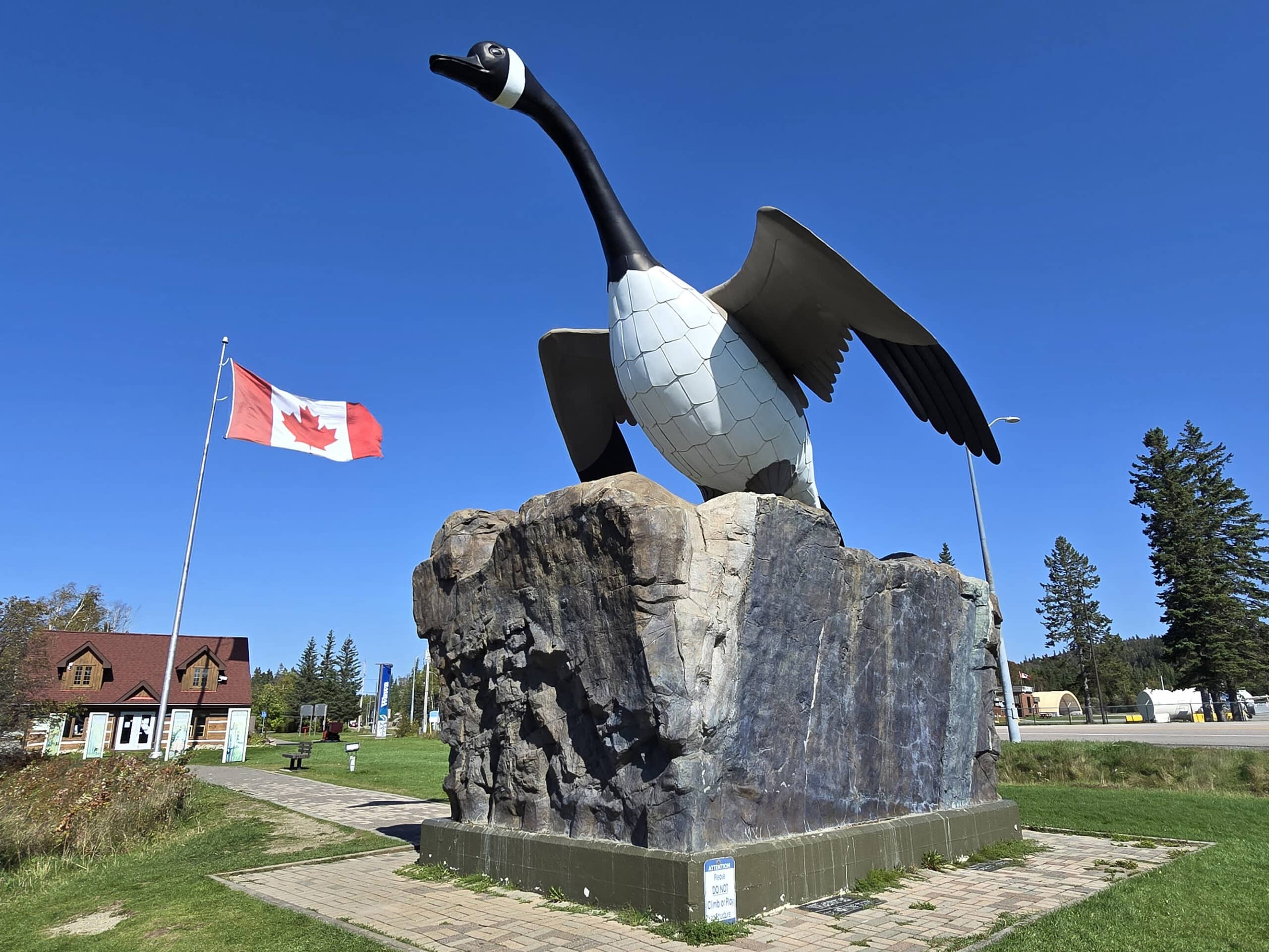The wawa goose statue with a Canadian flag in the background.