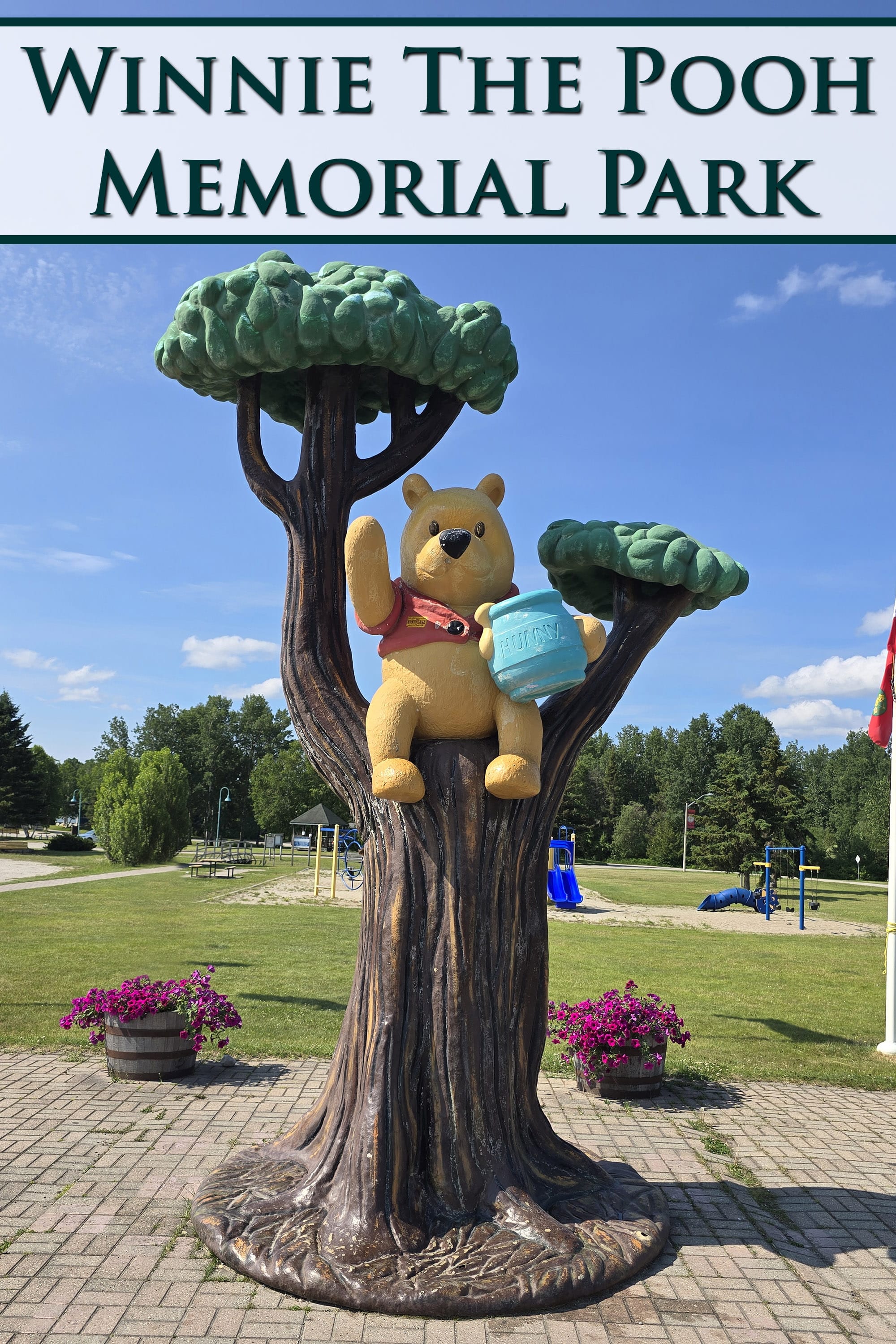 A statue of Winnie the Pooh in a tree, with a memorial park behind it. Overlaid text says Winnie the Pooh Memorial Park.