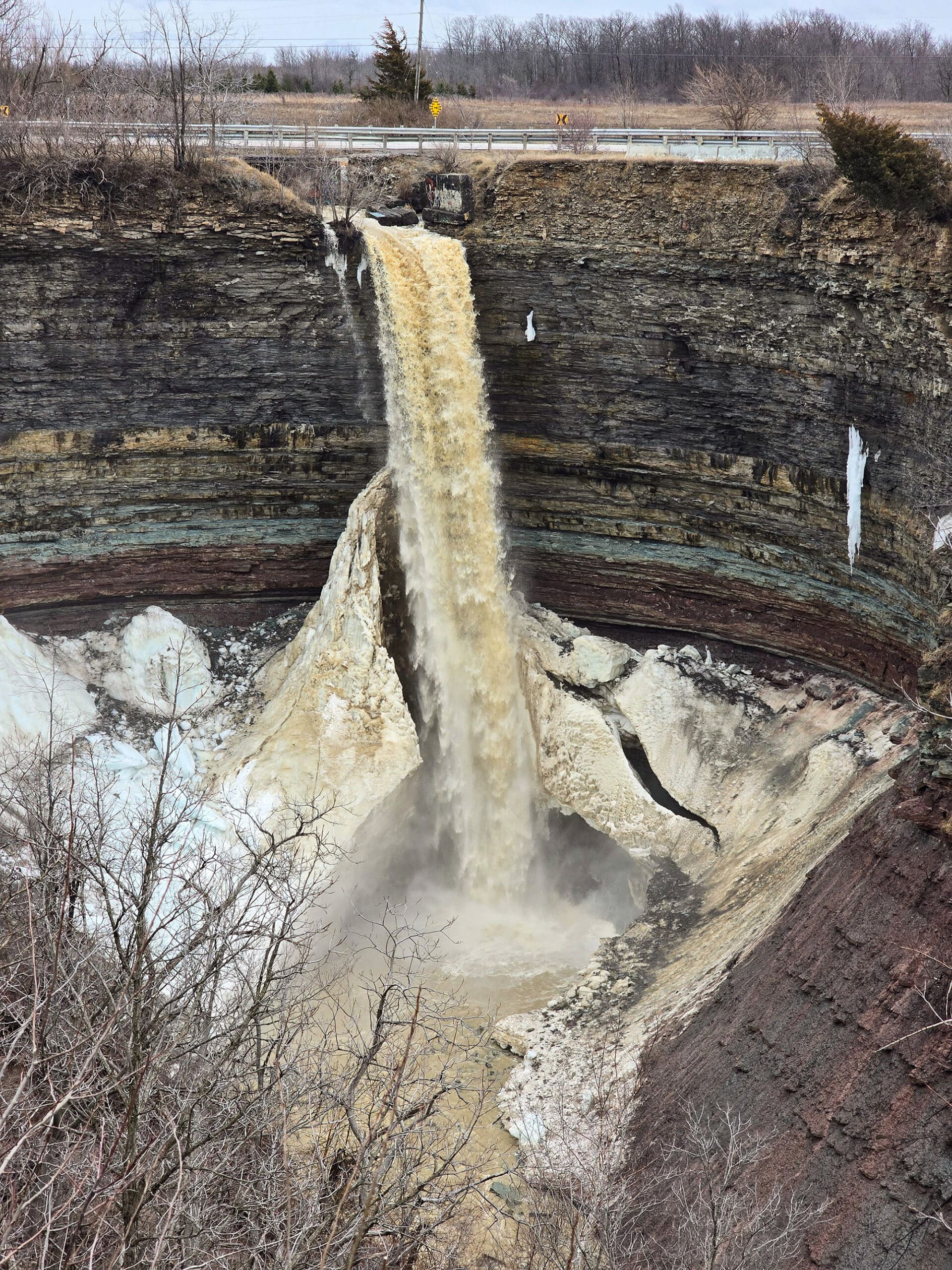 The Devil’s punchbowl waterfall partially frozen, in winter.