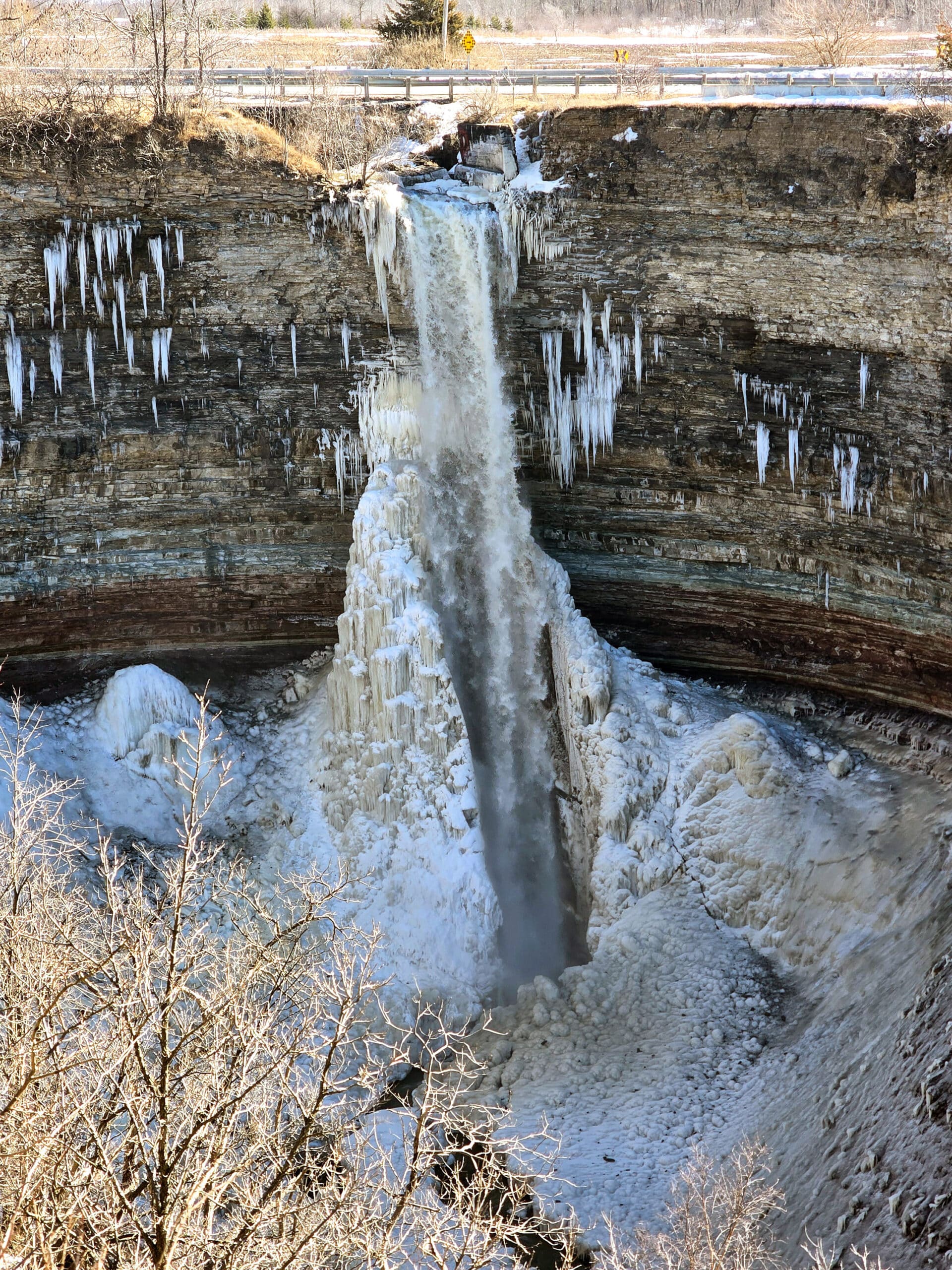 The Devil’s punchbowl waterfall partially frozen, in winter.