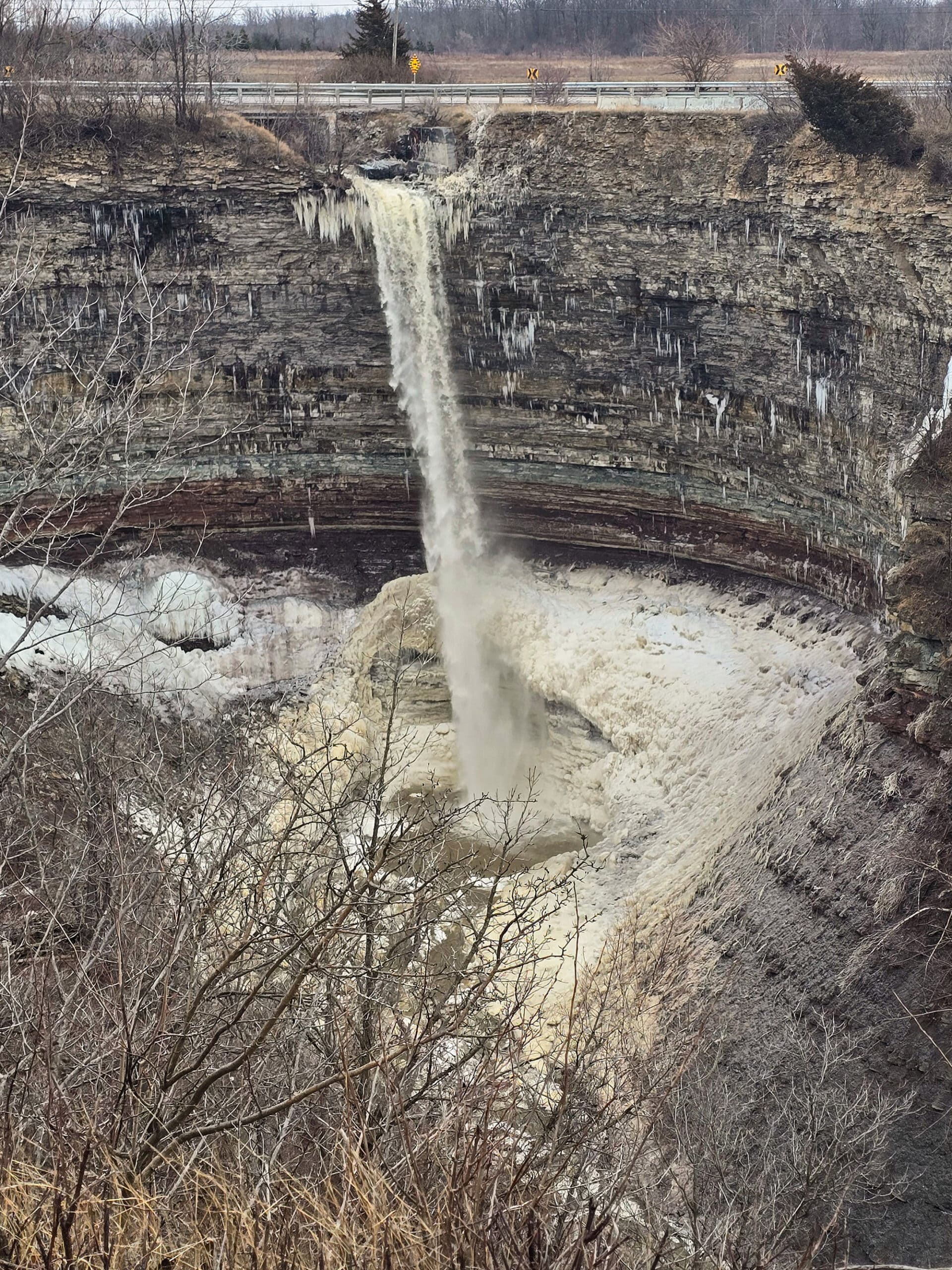 The Devil’s punchbowl waterfall partially frozen, in winter.