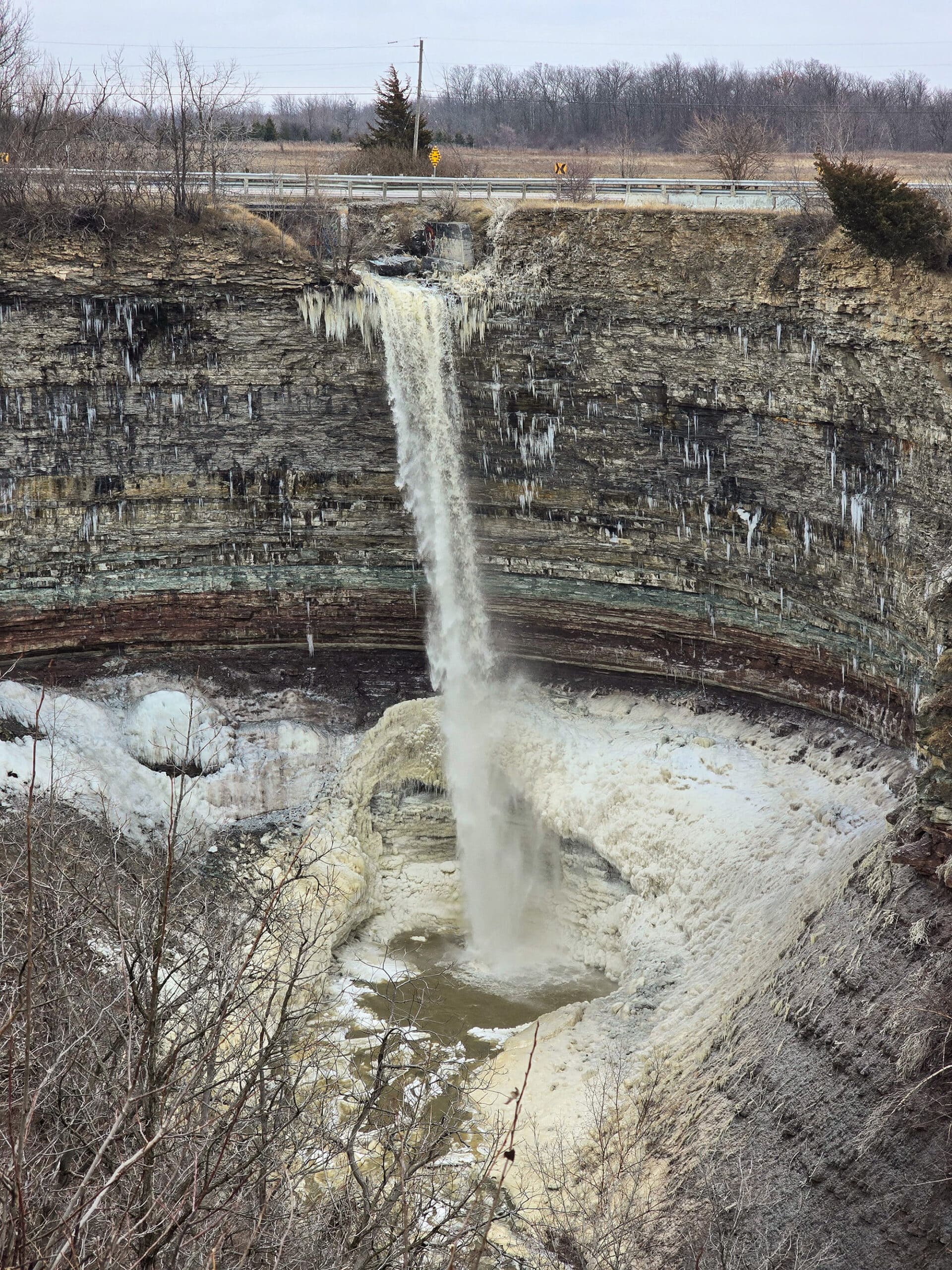 The Devil’s punchbowl waterfall partially frozen, in winter.