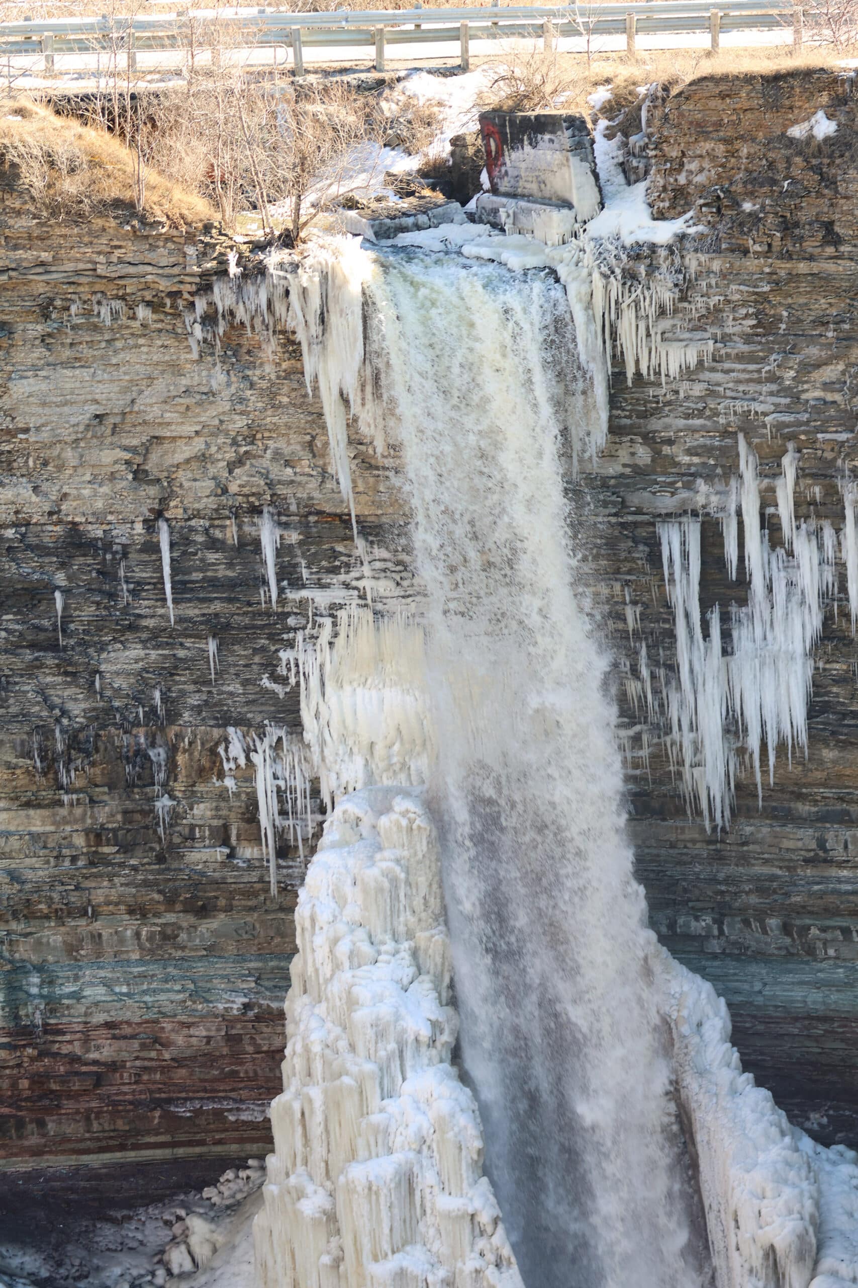 The Devil’s punchbowl waterfall partially frozen, in winter.