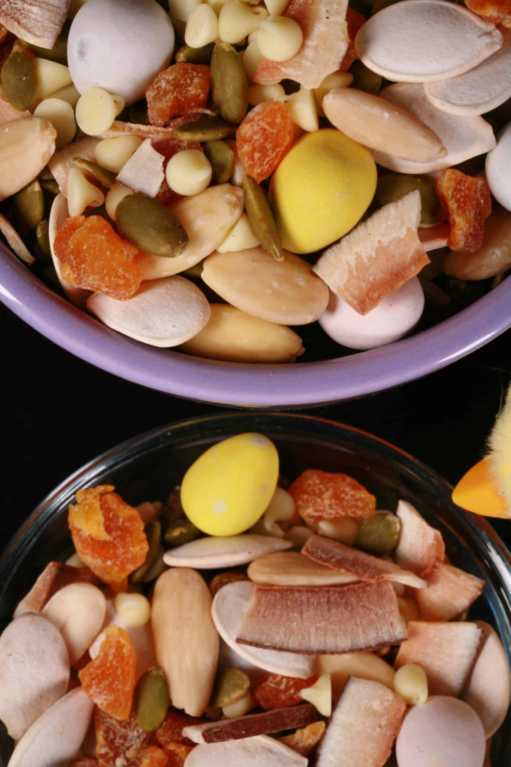 2 bowls of Easter trail mix, with coconut, apricot, pumpkin seeds, pepitas, which chocolate, and mini eggs.