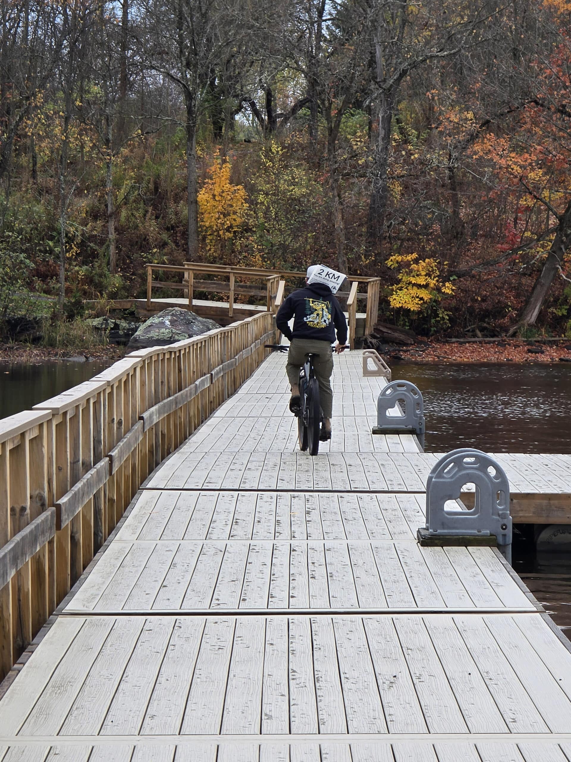 A cyclist on a section of floating boardwalk trail along the Hunter’s bay trail.