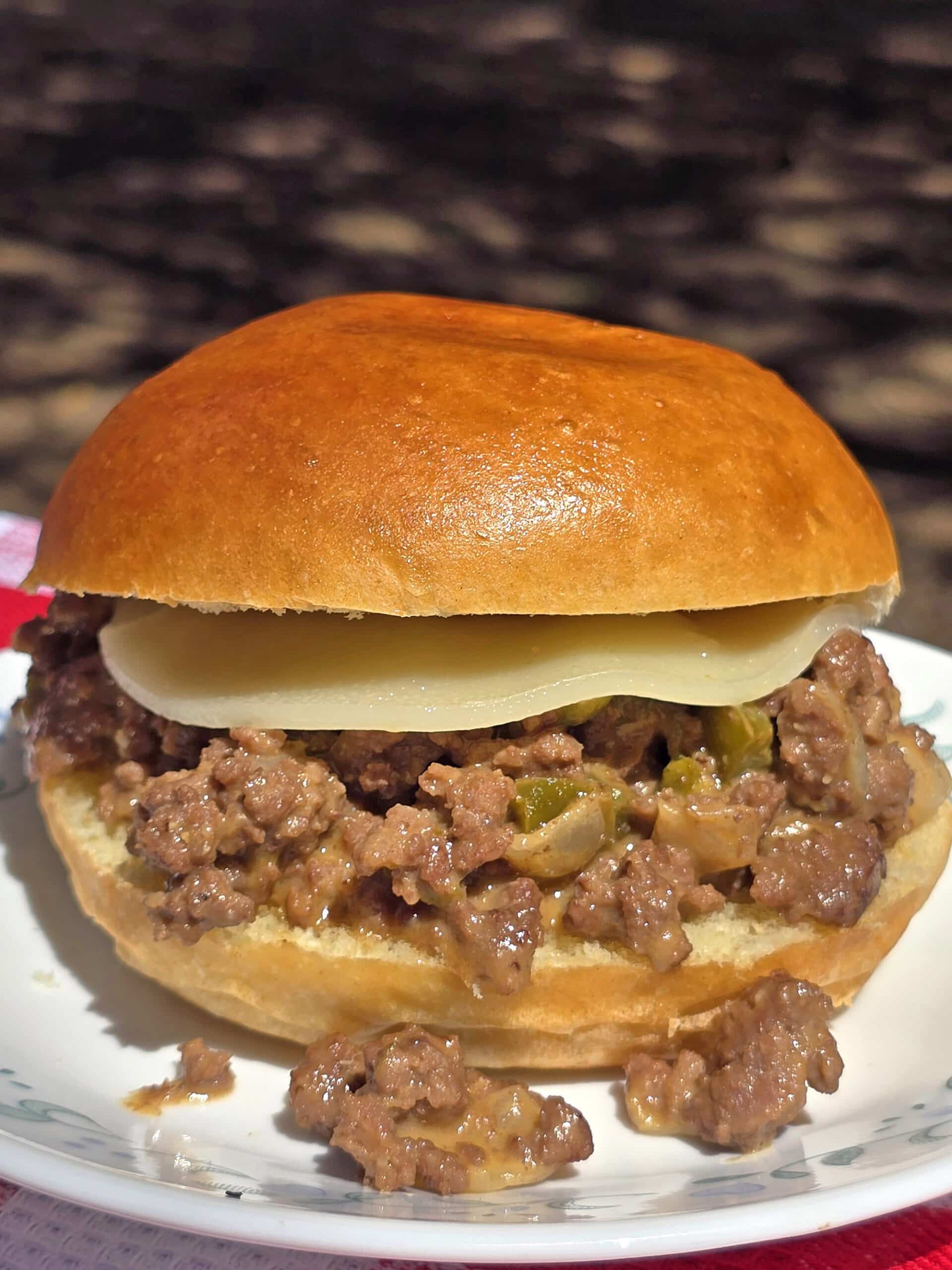 A Philly Cheesesteak Sloppy Joes sandwich with cheese sauce and provolone.