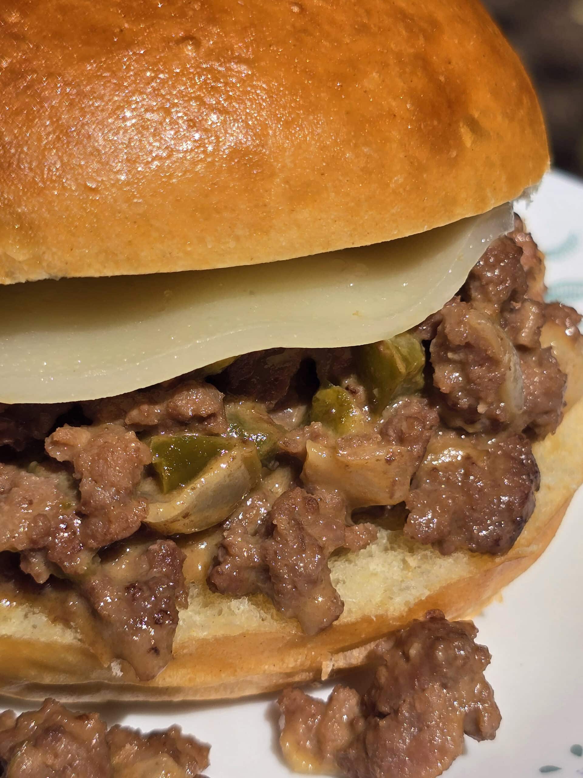 A Philly Cheesesteak Sloppy Joe sandwich with cheese sauce and provolone.