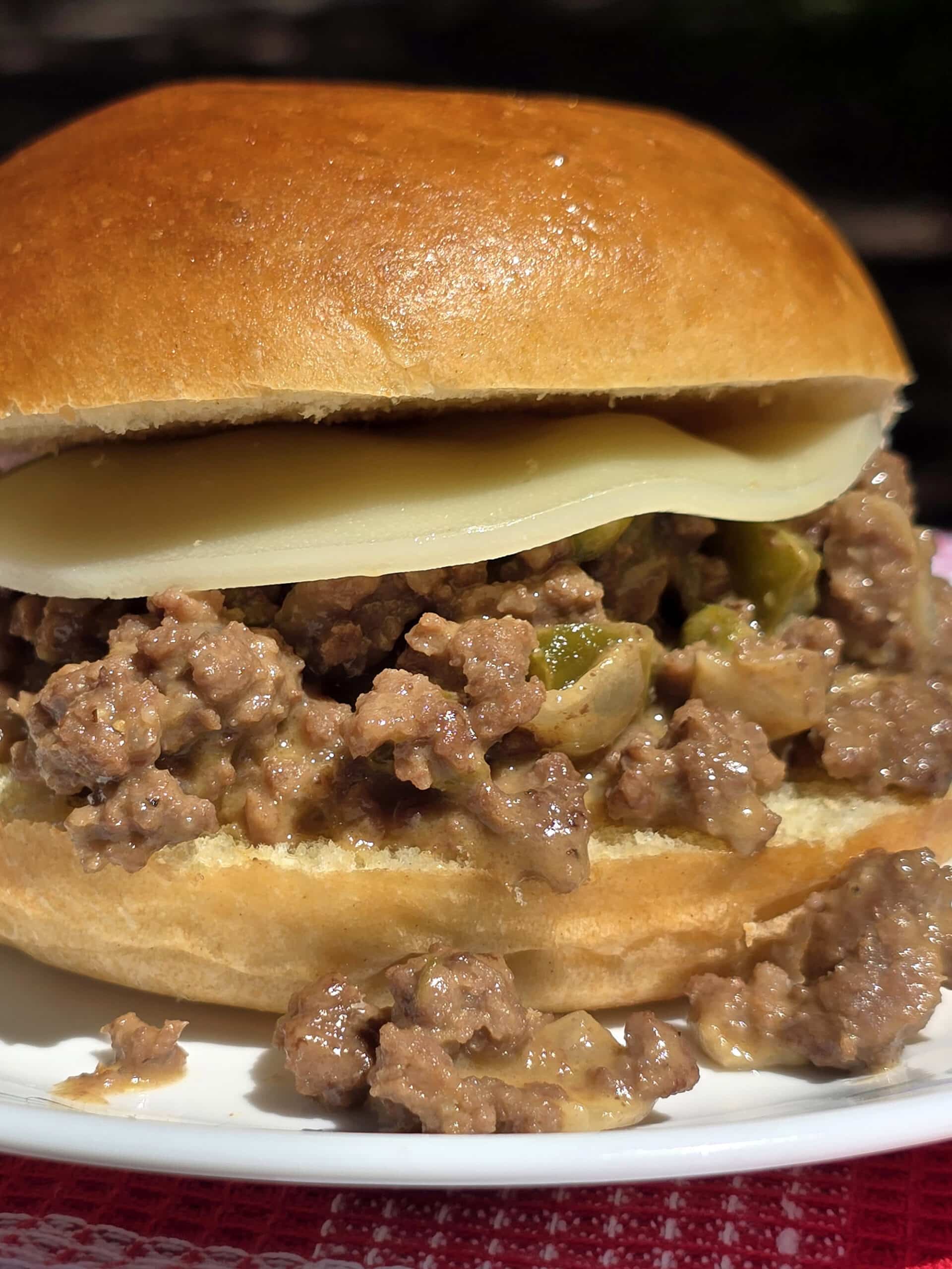 A Philly Cheesesteak Sloppy Joes sandwich with cheese sauce and provolone.