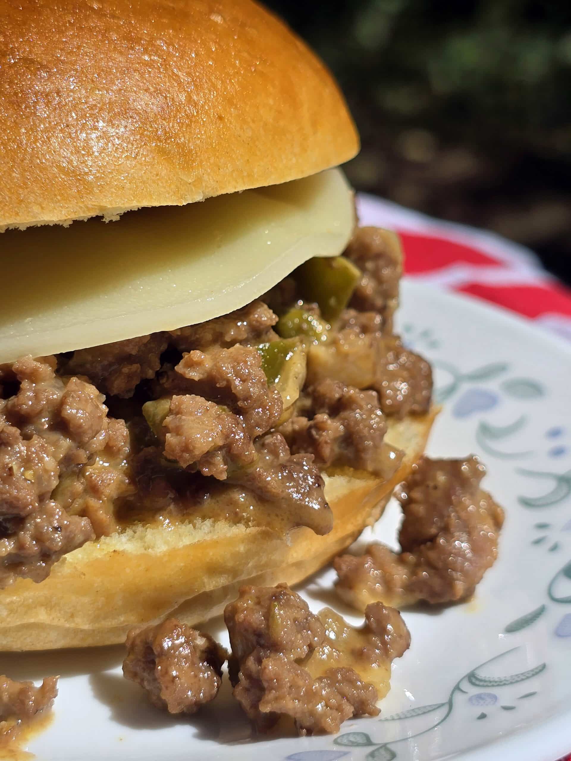 A Philly Cheesesteak Sloppy Joe sandwich with cheese sauce and provolone.