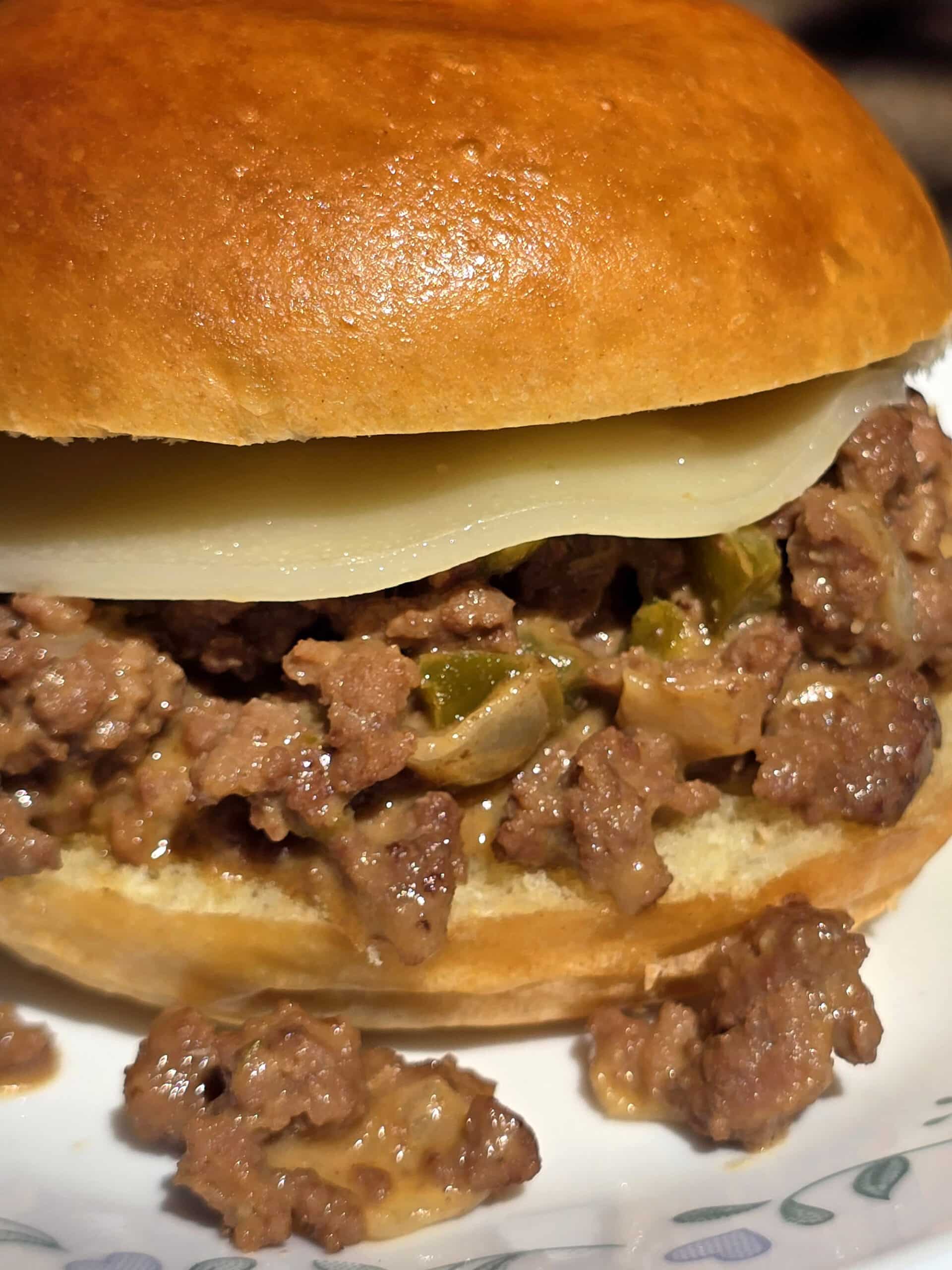 A Philly Cheesesteak Sloppy Joes sandwich with cheese sauce and provolone.