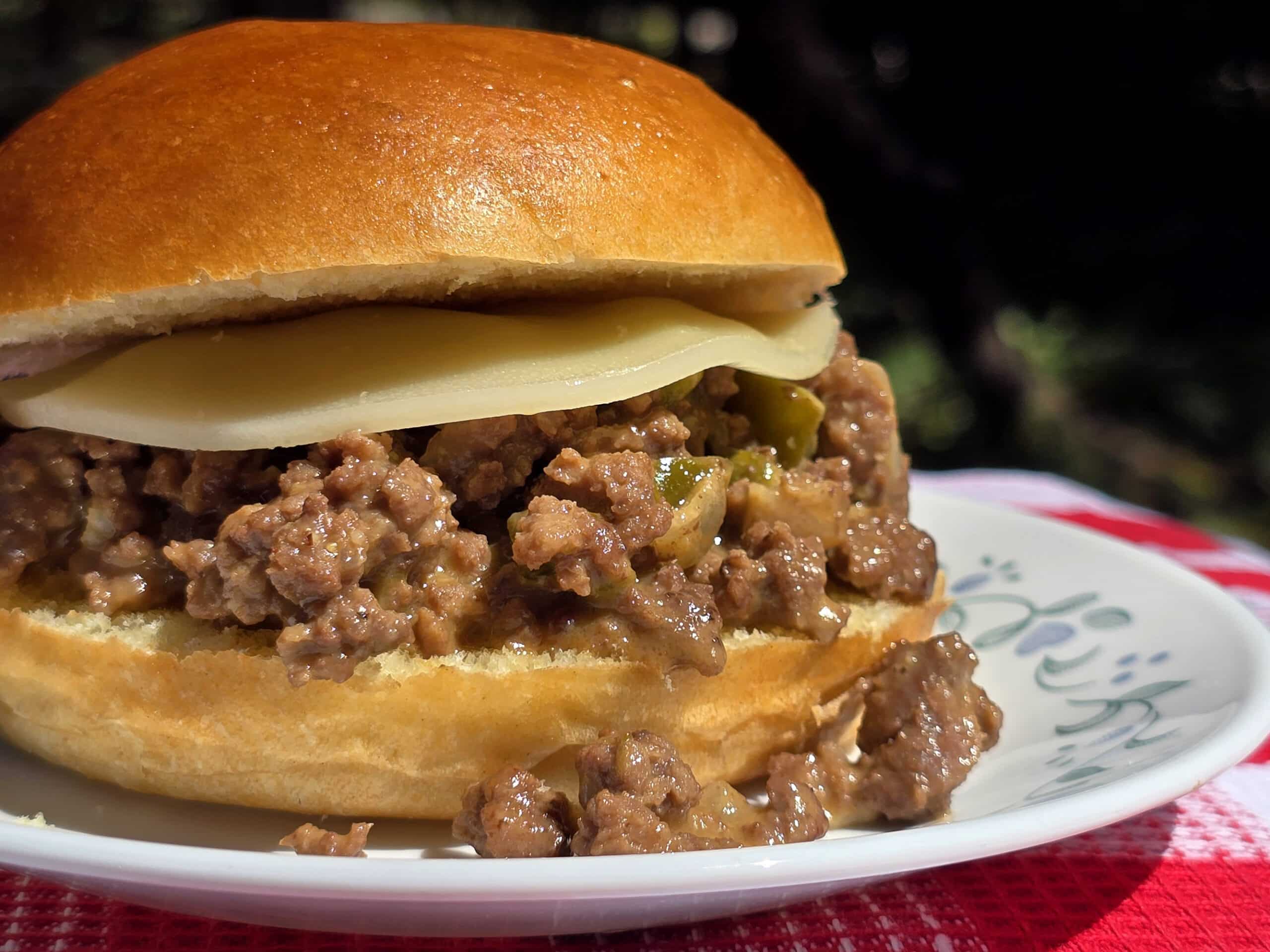 A Philly Cheesesteak Sloppy Joe sandwich with cheese sauce and provolone.
