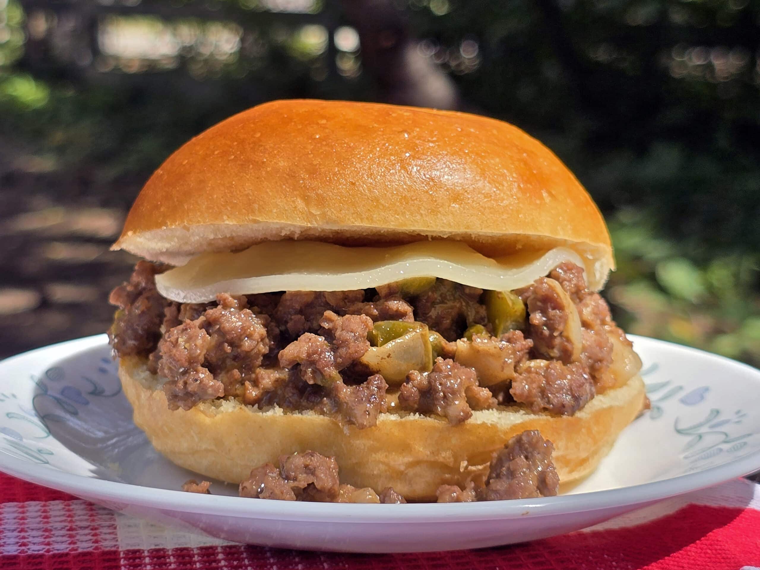 A Philly Cheesesteak Sloppy Joes sandwich with cheese sauce and provolone.