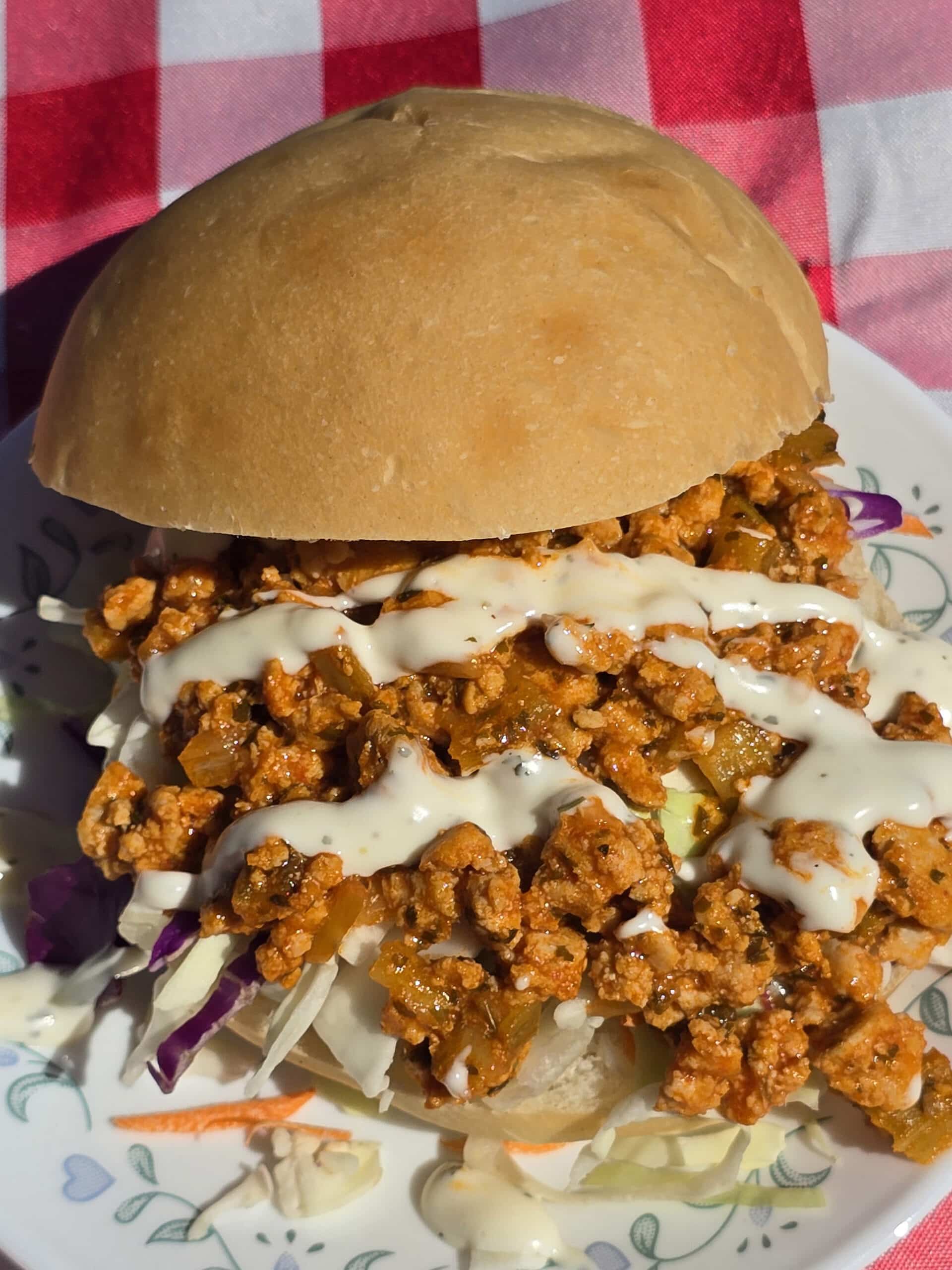 A buffalo chicken sloppy joe sandwich with cabbage and ranch dressing.