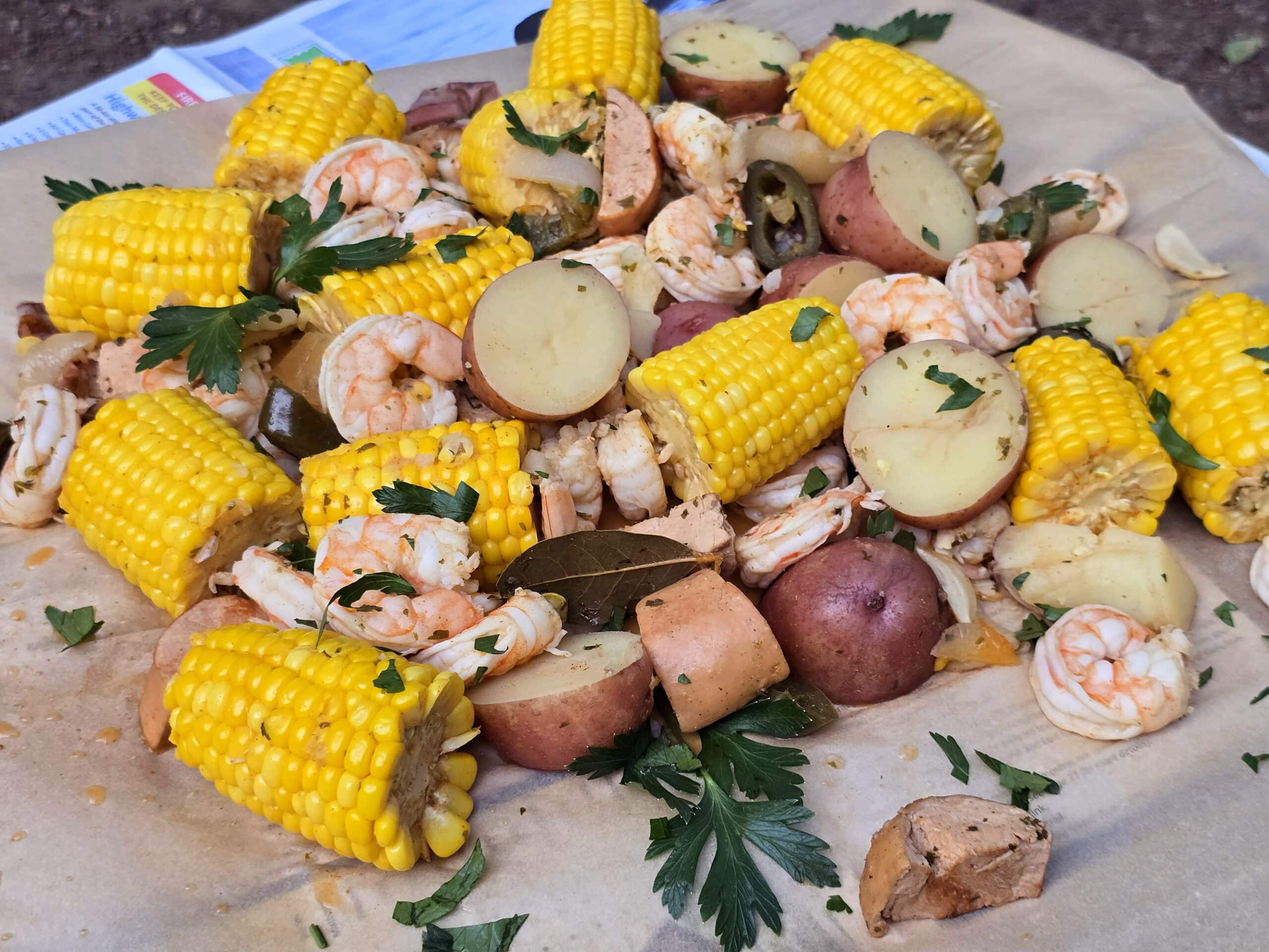 A pot of shrimp boil after straining and dumping out onto parchment.