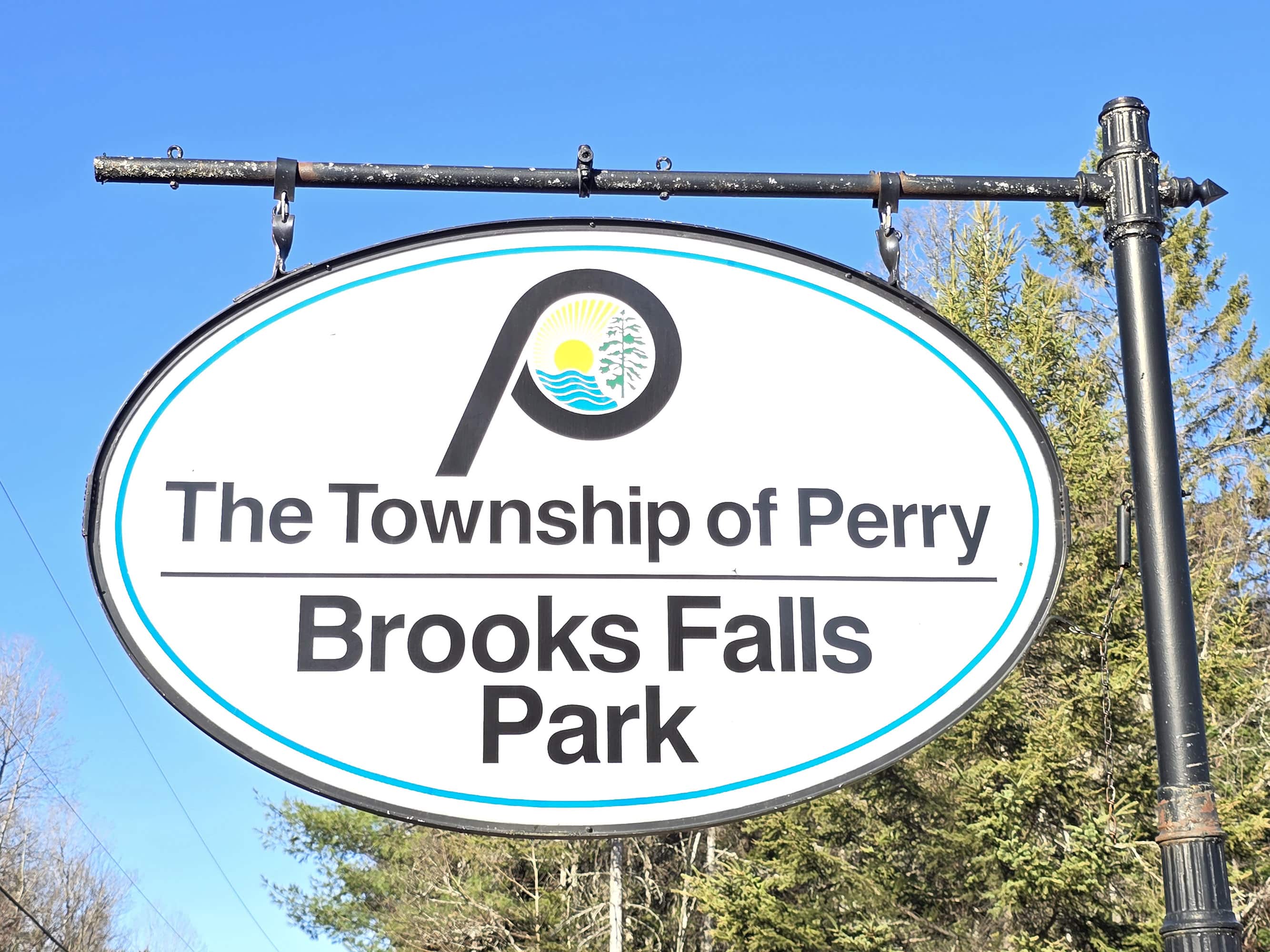 A road sign for the township of perry, brooks falls park.