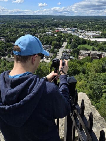 A man on Dundas Peak, overlooking the city of Hamilton.