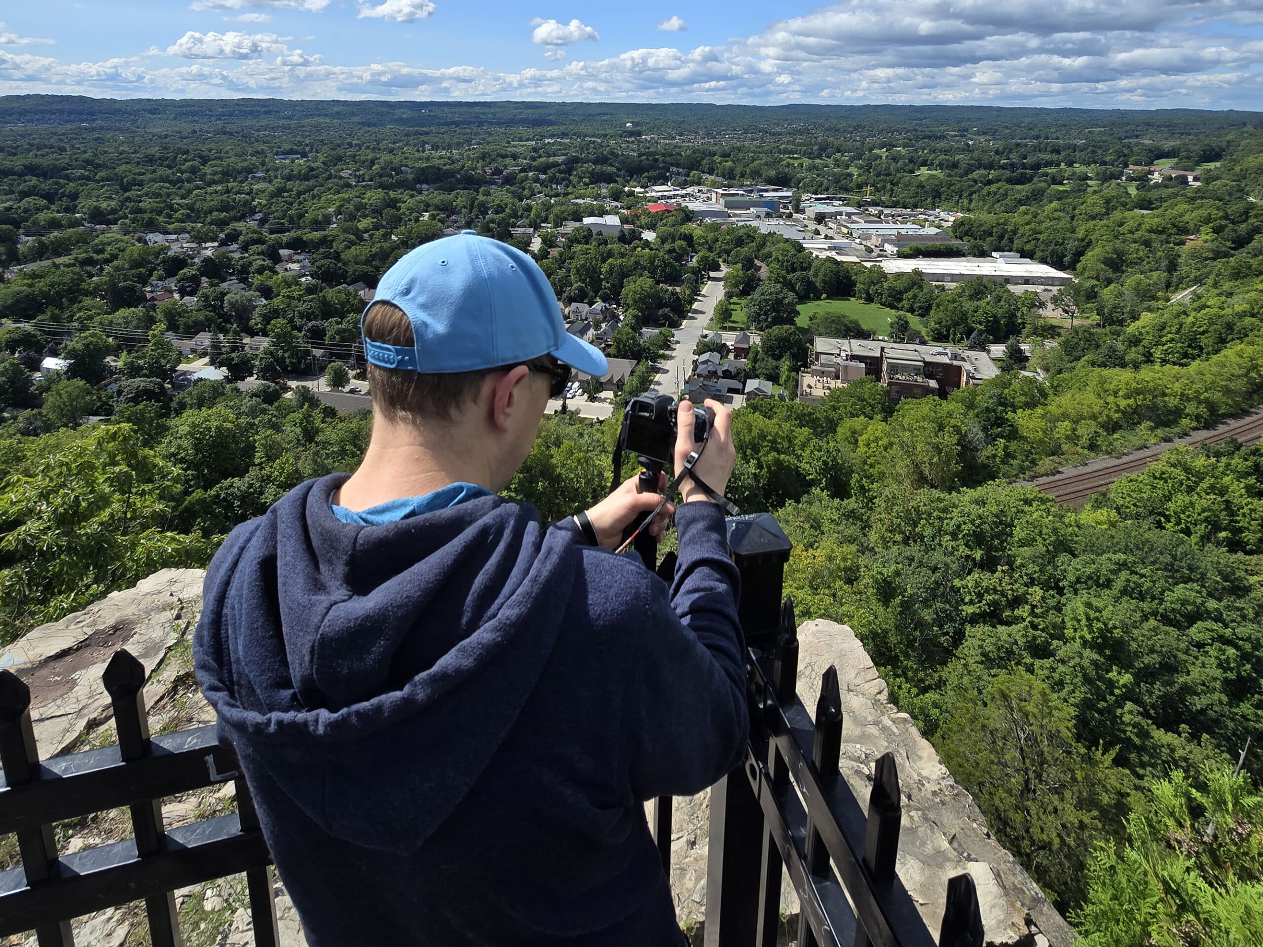 A man on Dundas Peak, overlooking the city of Hamilton.
