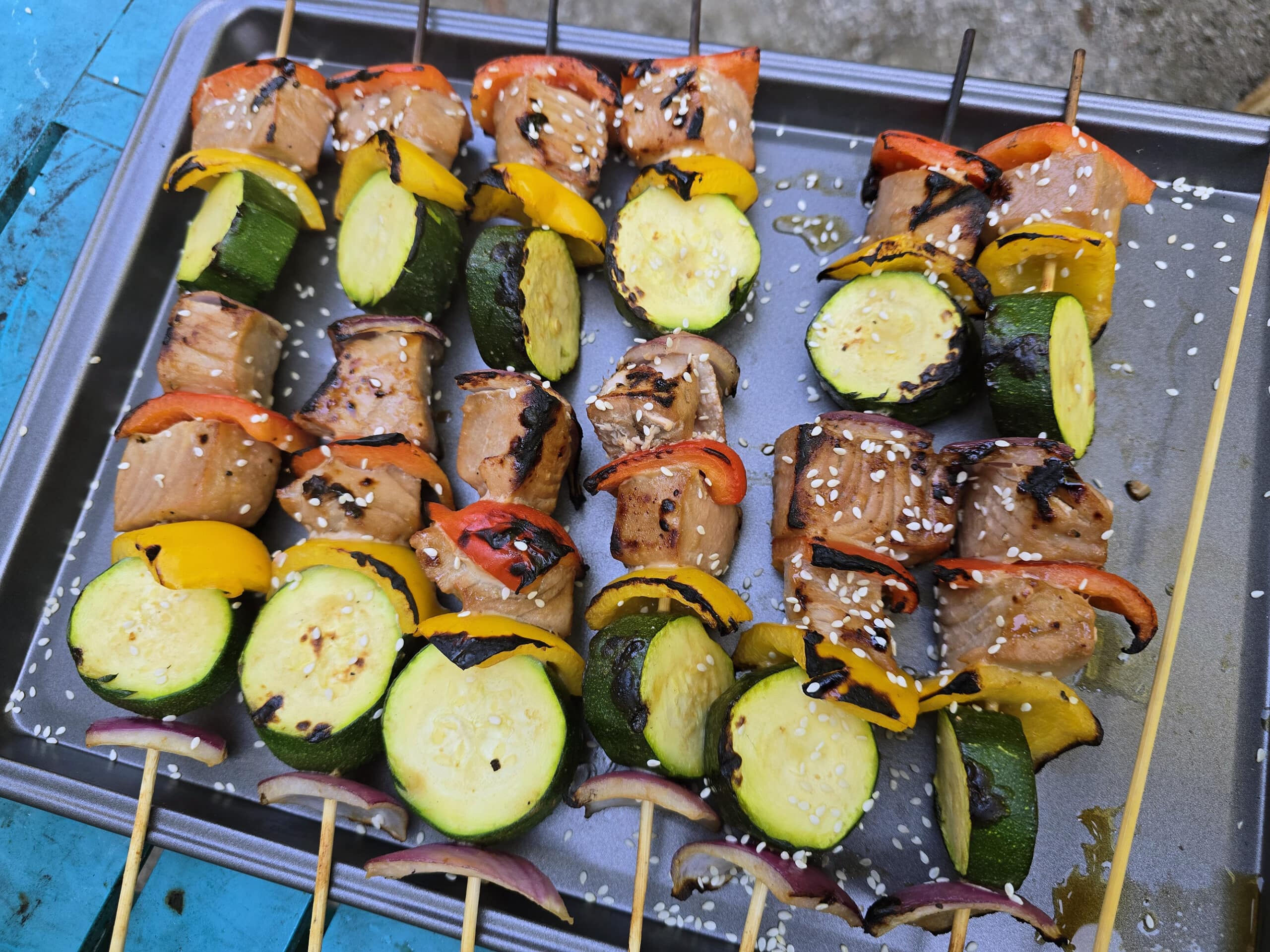 6 sesame ginger tuna kebabs on a baking pan.