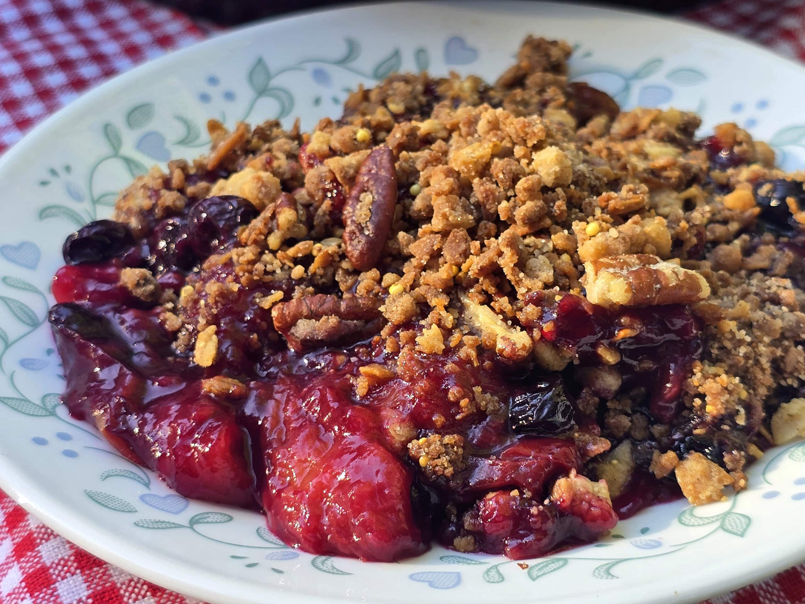 A plate of blueberry peach crisp.