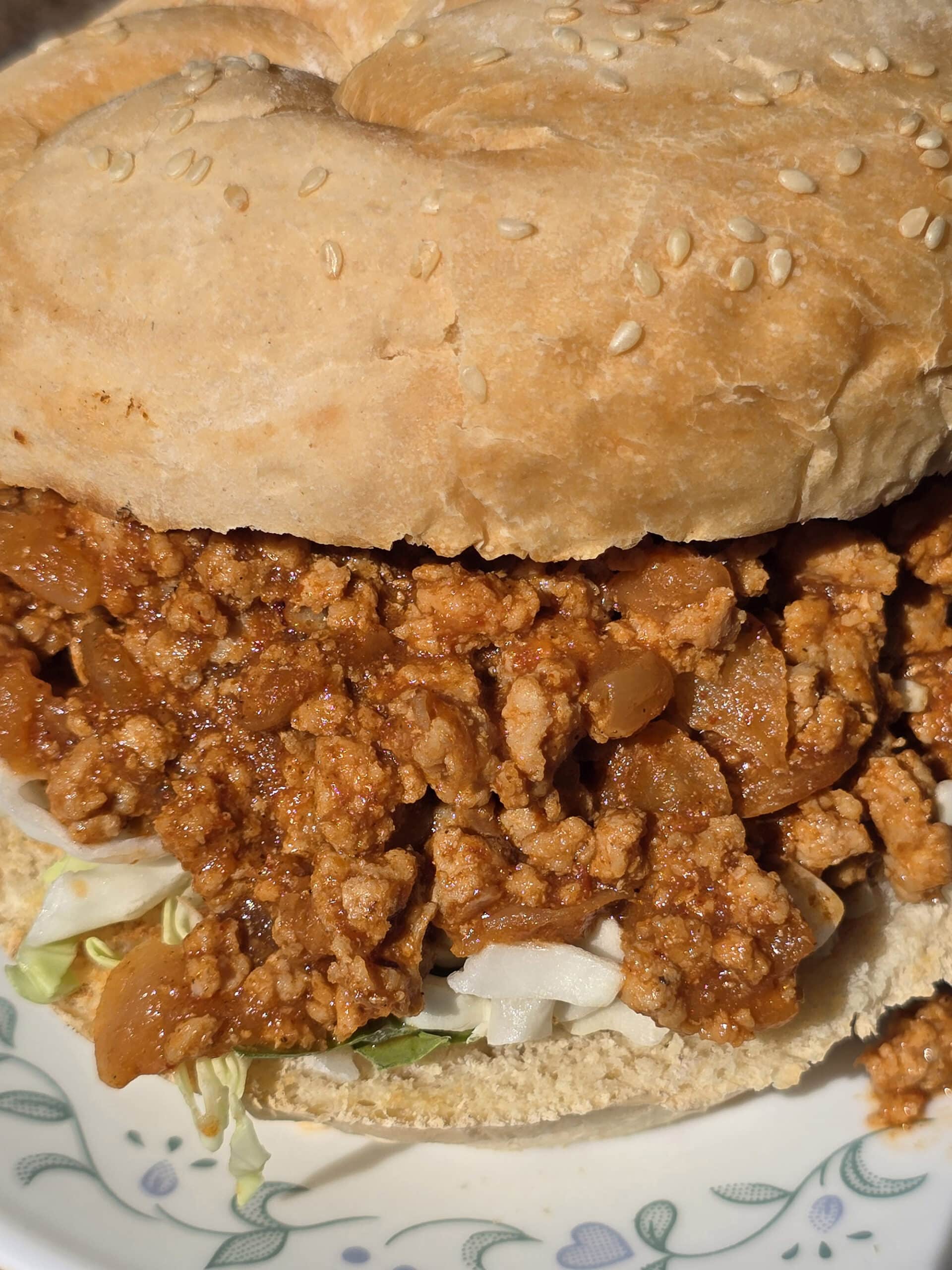 An Ethiopian Sloppy Joes sandwich with berbere spiced ground chicken and shredded cabbage.