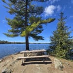 A picnic table on a small penisula overlooking Silver Lake.
